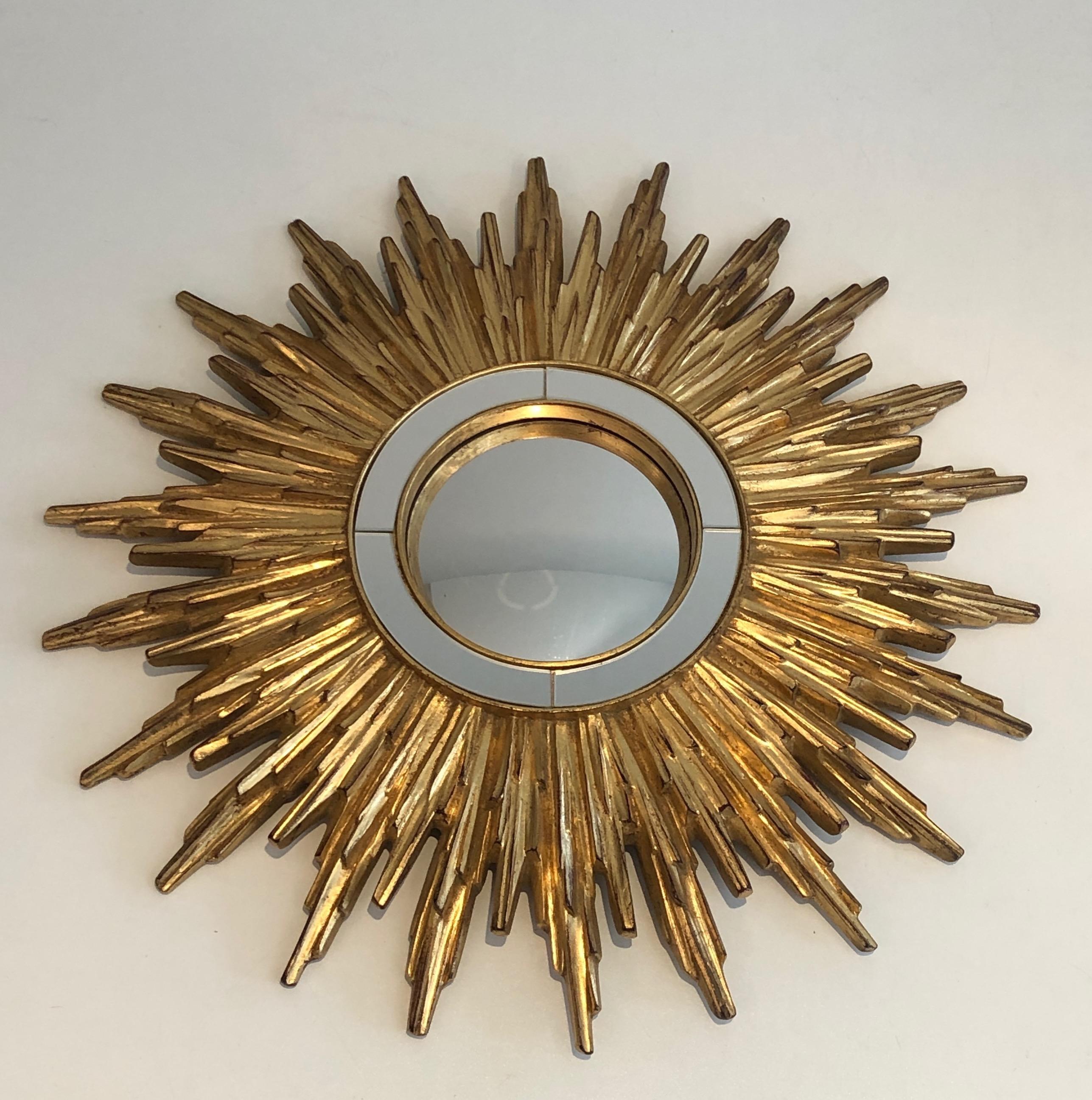 Thus very nice sunburst is made of gilt resin and mirror. This is a French work, circa 1970.