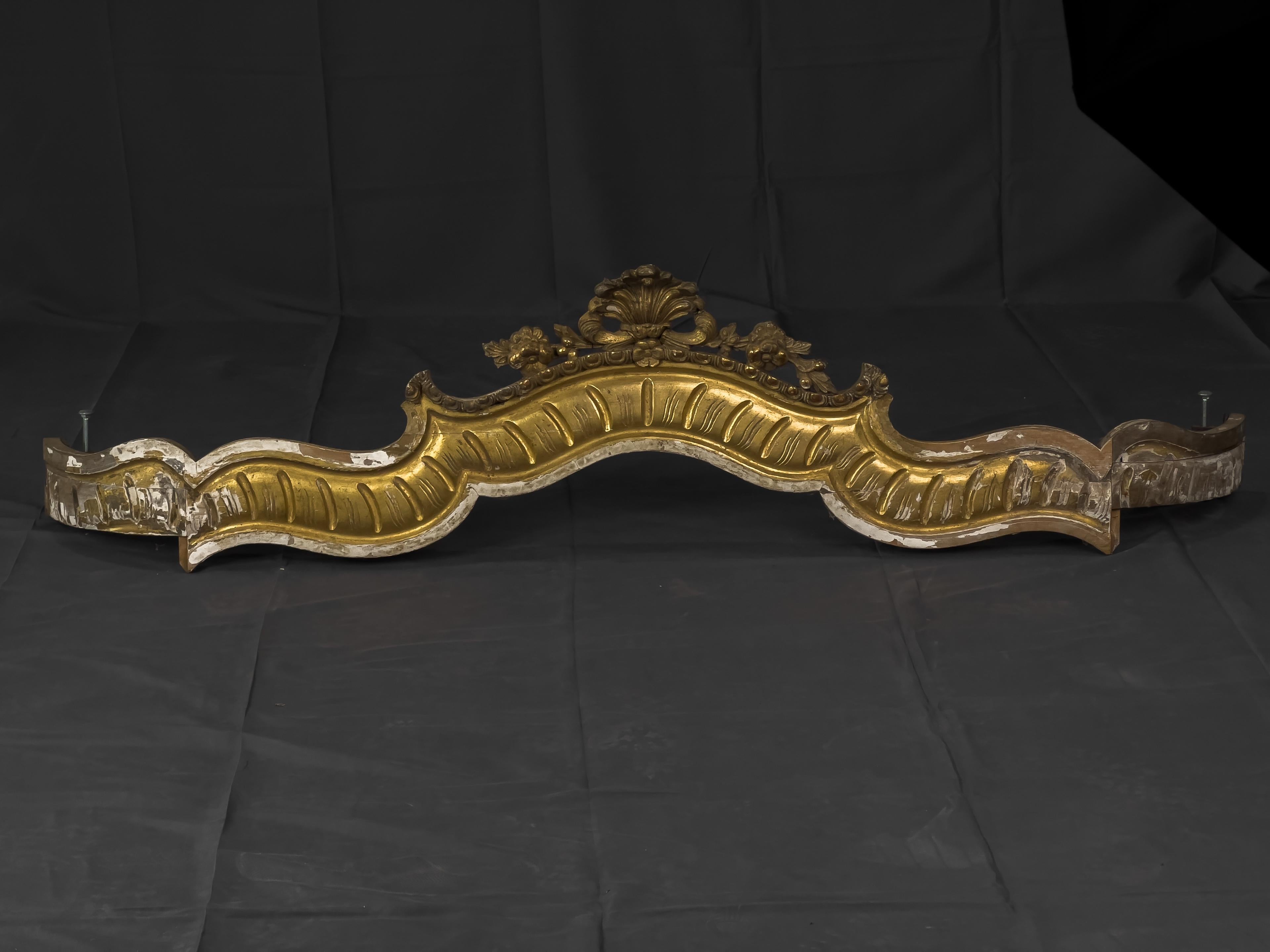 Gilt Rococo style bed crown canopy with carved detail and curvilinear shape.