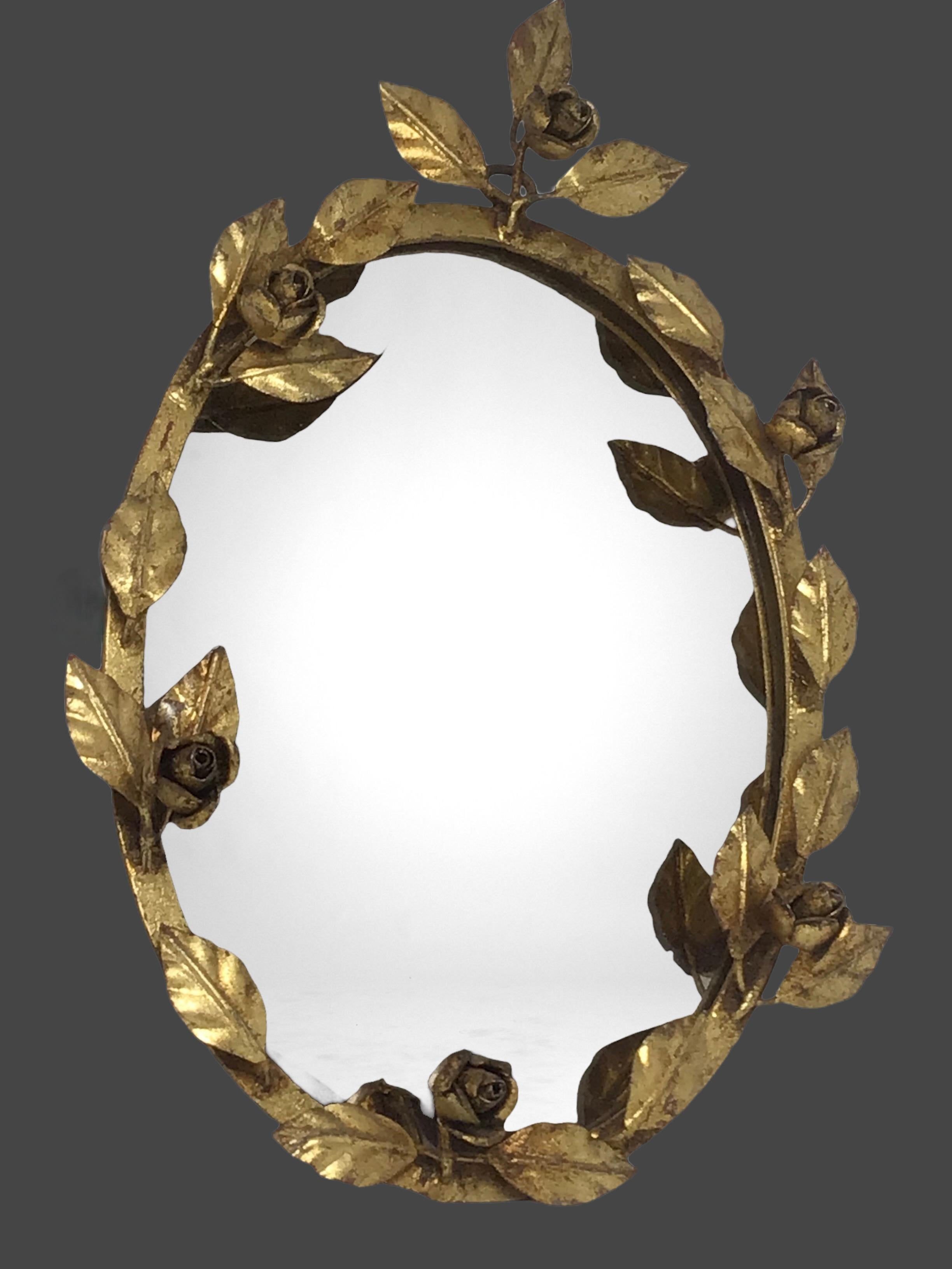 A gorgeous Hollywood Regency mirror. Made of gilded metal. Mirror in good condition, like seen in the pictures. Mirror glass in smoked color. The metal with patina, but this is old-age. A nice addition to any room.