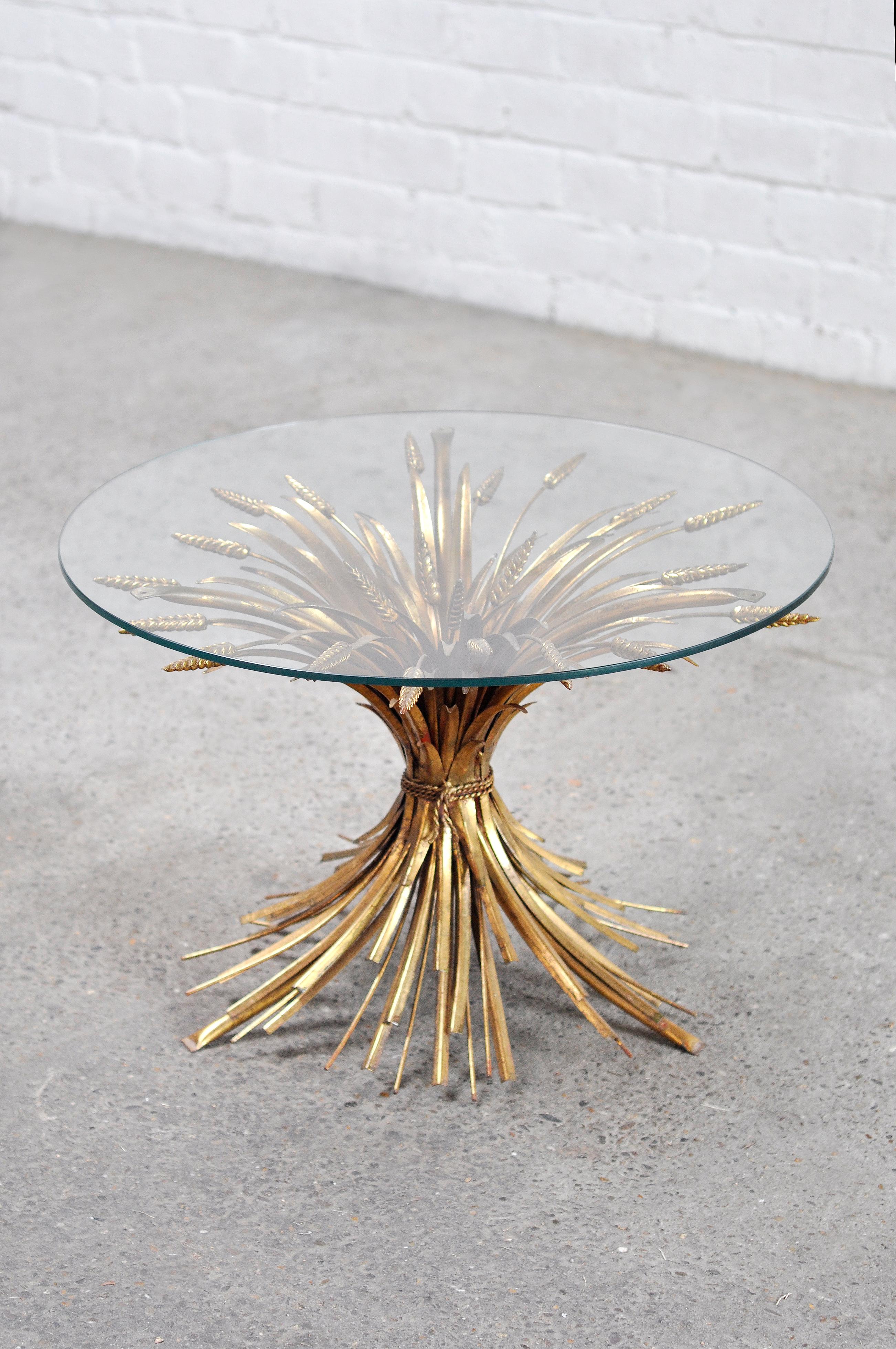 Gilt sheaf of wheat side table in the style of Coco Chanel, 1960's. Features a stunning patinated gold metal frame, in the shape of a sheaf of wheat. This design became famous when both Coco Chanel and Yves Saint Laurent utilized them in their own