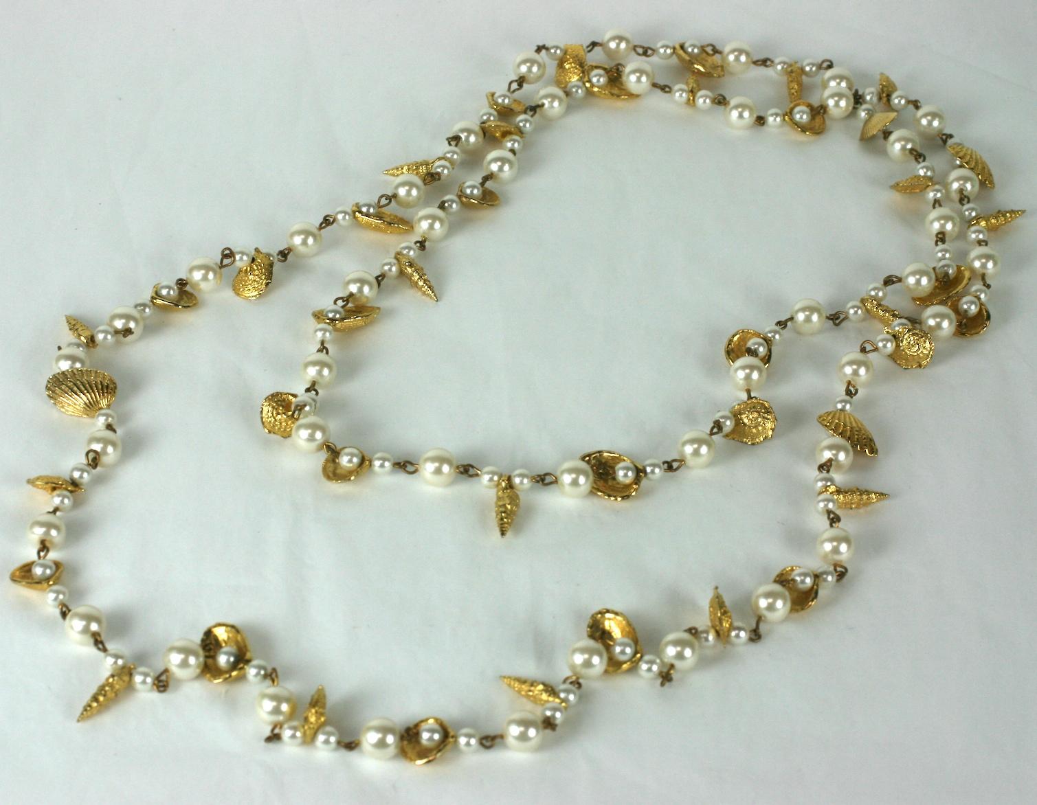 Gilt Shell and Faux Pearl Lariat, super long in length to layer and wrap as needed. Different gilded shells are dispersed though out this faux pearl necklace.
1980's USA. 
60