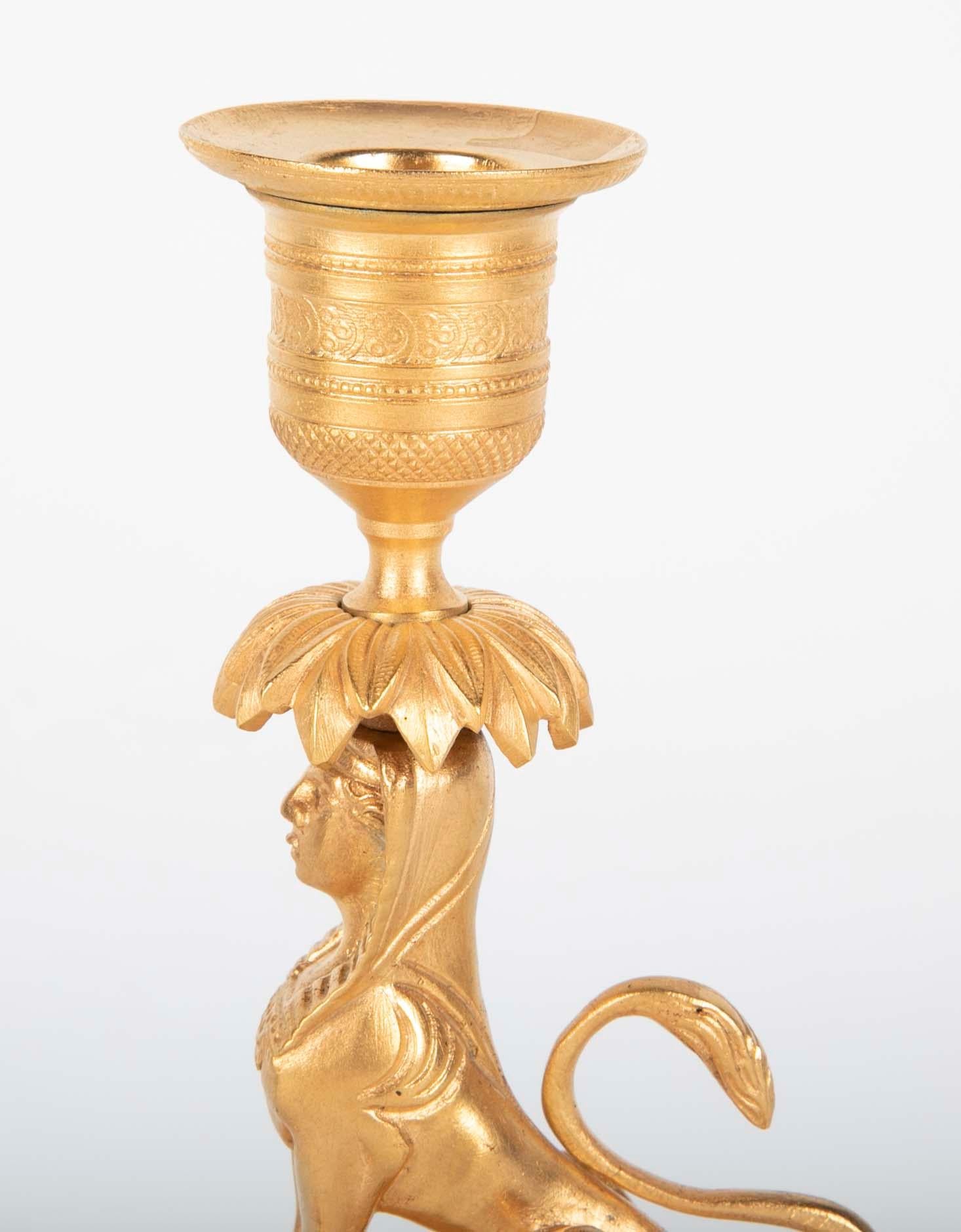 Gilt Sphinx Themed Candlestick on a Stepped Marble Base In Good Condition For Sale In Stamford, CT