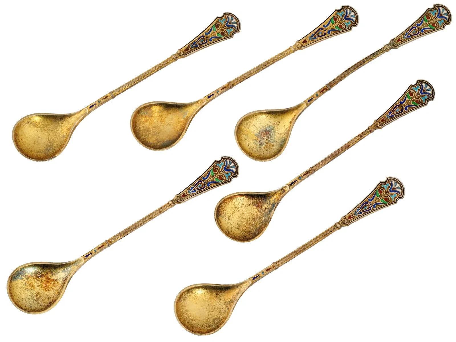 A vintage gilt sterling silver and enamel spoon set. Presumably of Russian origin. A total of 6 spoons. Circa the first half of the 20th century. Marked with 925 sterling silver standard on the back side. Comes with the original box covered with red