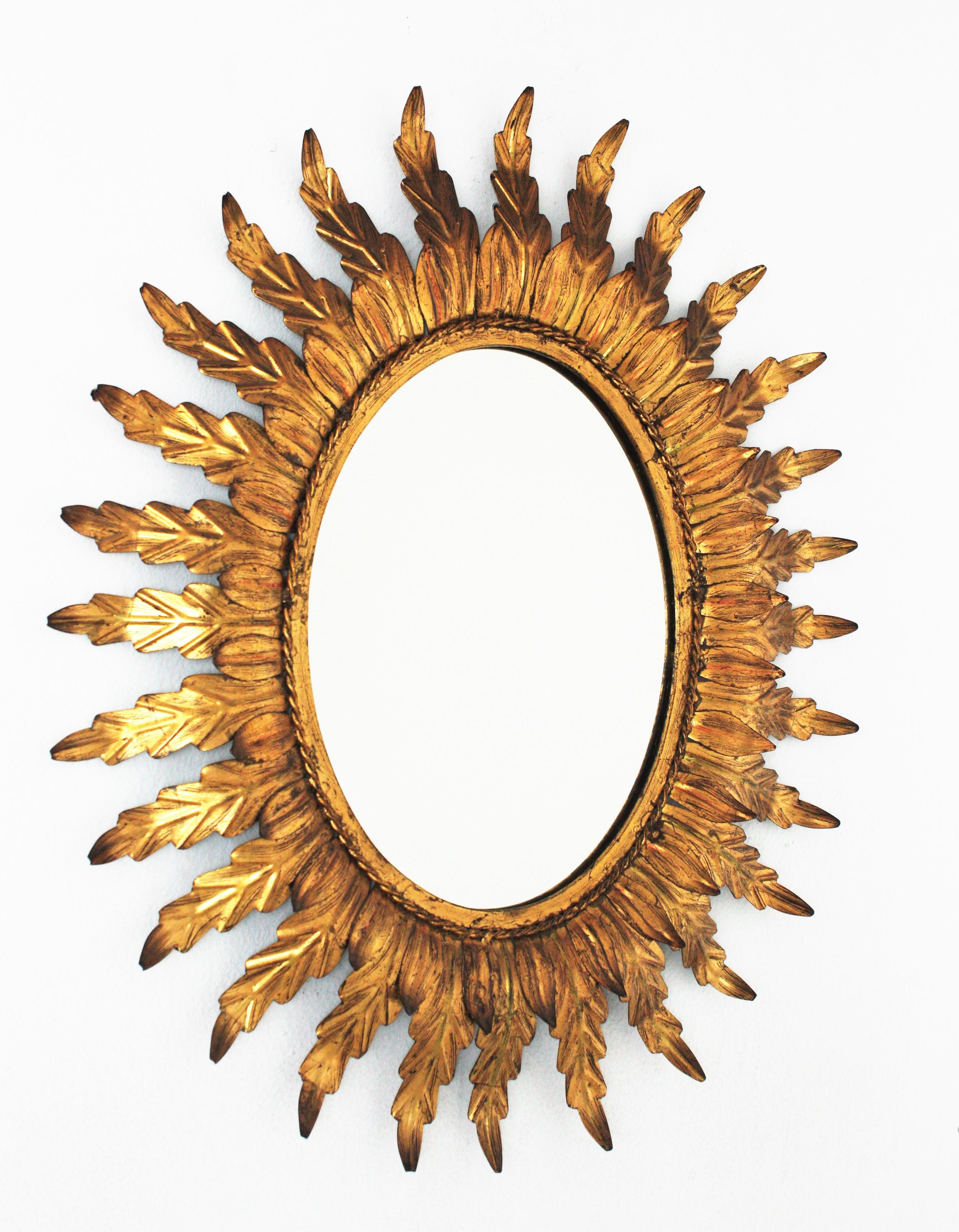 Hollywood Regency Gilt Sunburst Oval Mirror with Foliage Frame For Sale