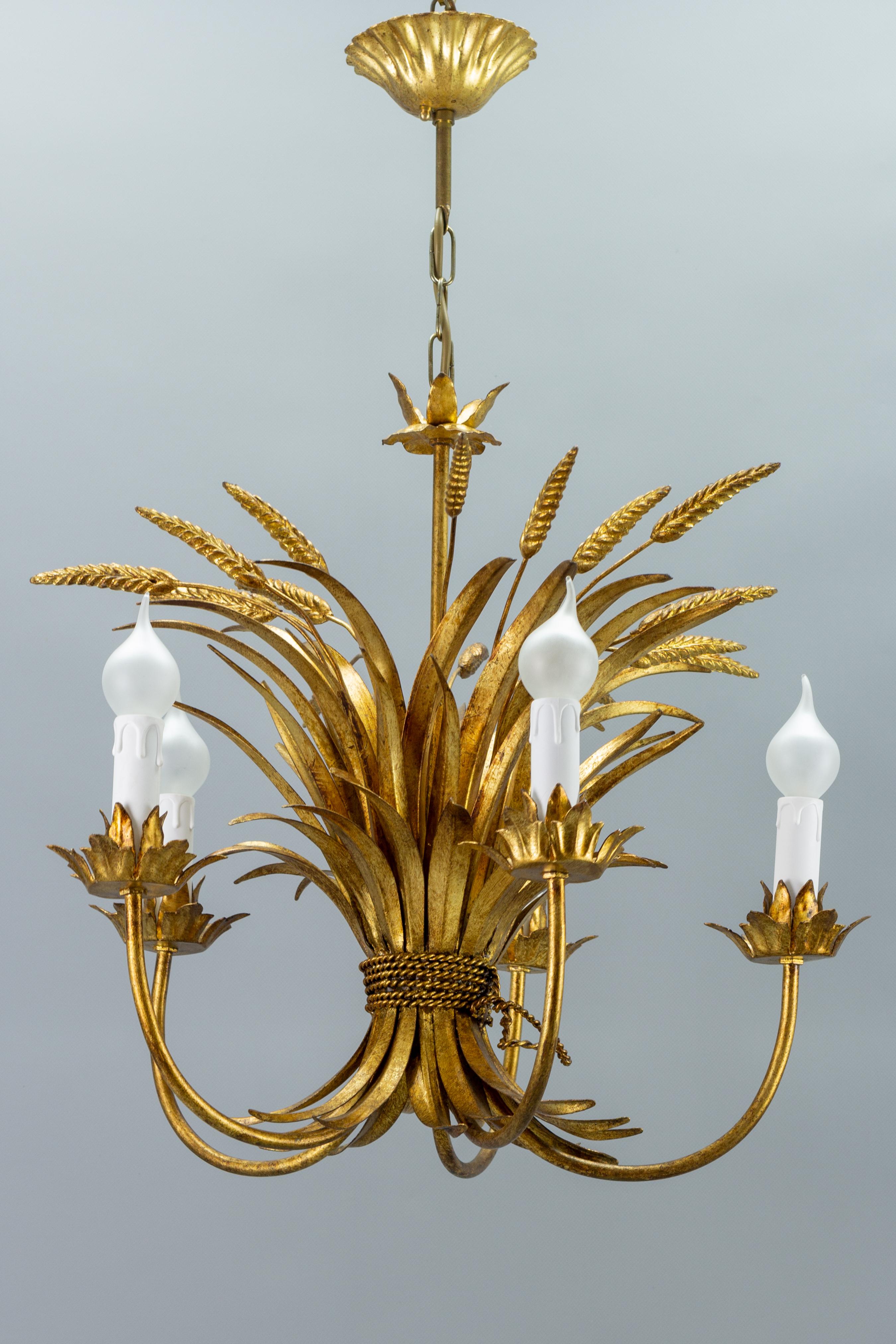 This beautiful five-light chandelier features a rich sheaf of gilded tole leaves and ears of wheat, decoratively tied with a gilt tole cord.
Five arms, each with a socket for the E14 size light bulb, new sockets, and candle covers.
Dimensions: