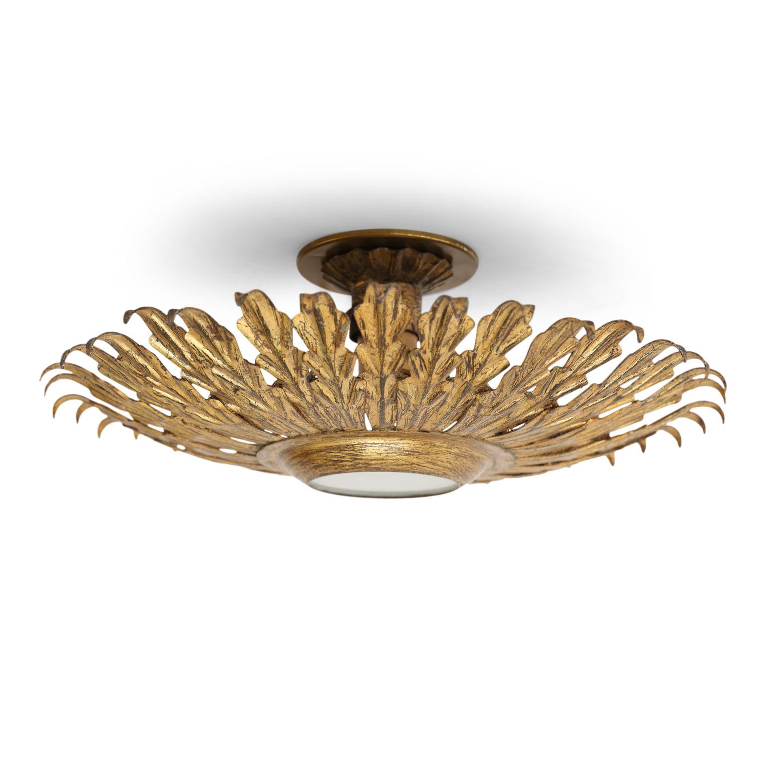Gilt tole flush mount light for your ceiling or wall. Sunburst design of gilt tole leaves radiating from frosted glass shade. This vintage Spanish light dates from about 1950-1970 (Barcelona) and is newly wired for use within the USA. Accommodates a