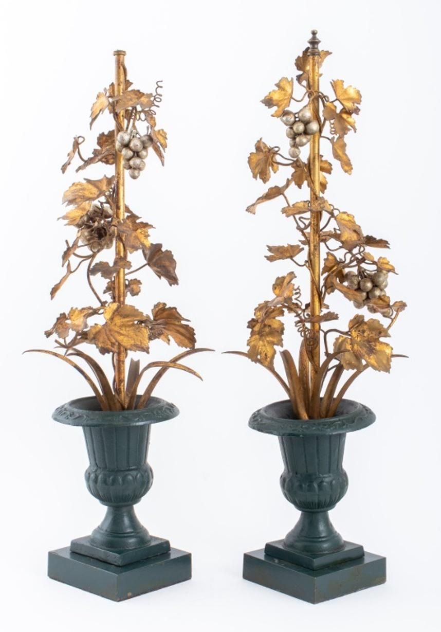 Pair of European, possibly French, gilt tole vining branches with silvered grape bunches in green-painted stoneware urns mounted atop green-painted metal square bases, formerly lamps. One finial lacking.

Dimensions: Overall: 31.5