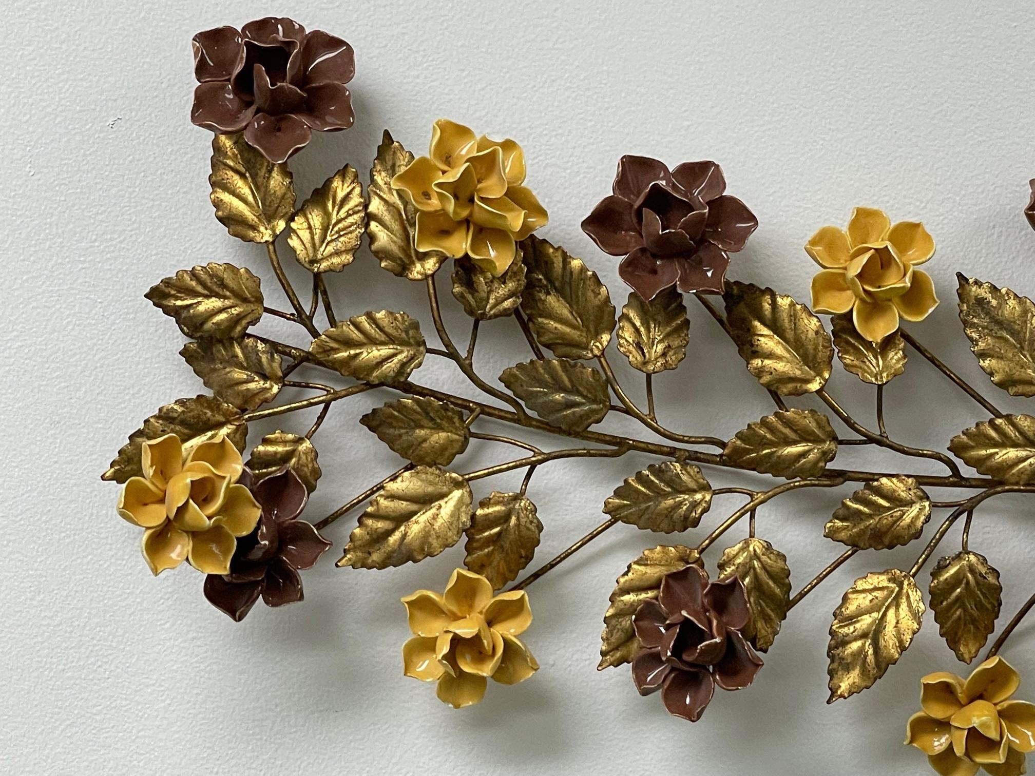Mid-century Florentine toleware wall sculpture features a vine of gold leaves with ceramic roses in gold and brown. Made in Italy tag present. Good condition with minor imperfections consistent with age (see photos).