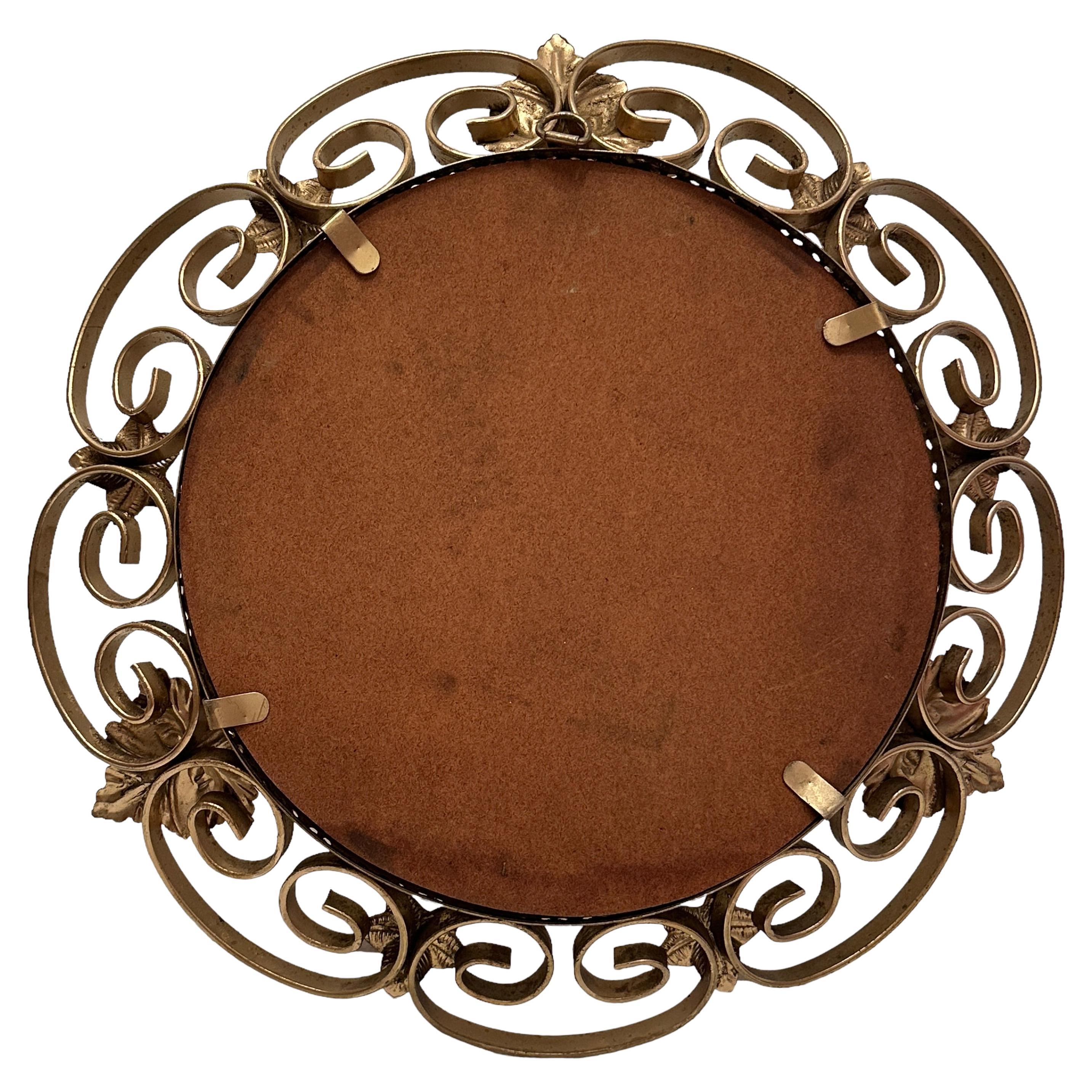 A gorgeous Hollywood Regency mirror. Made of gilded metal. No chips, no cracks, no repairs. It measures approximate 14.25