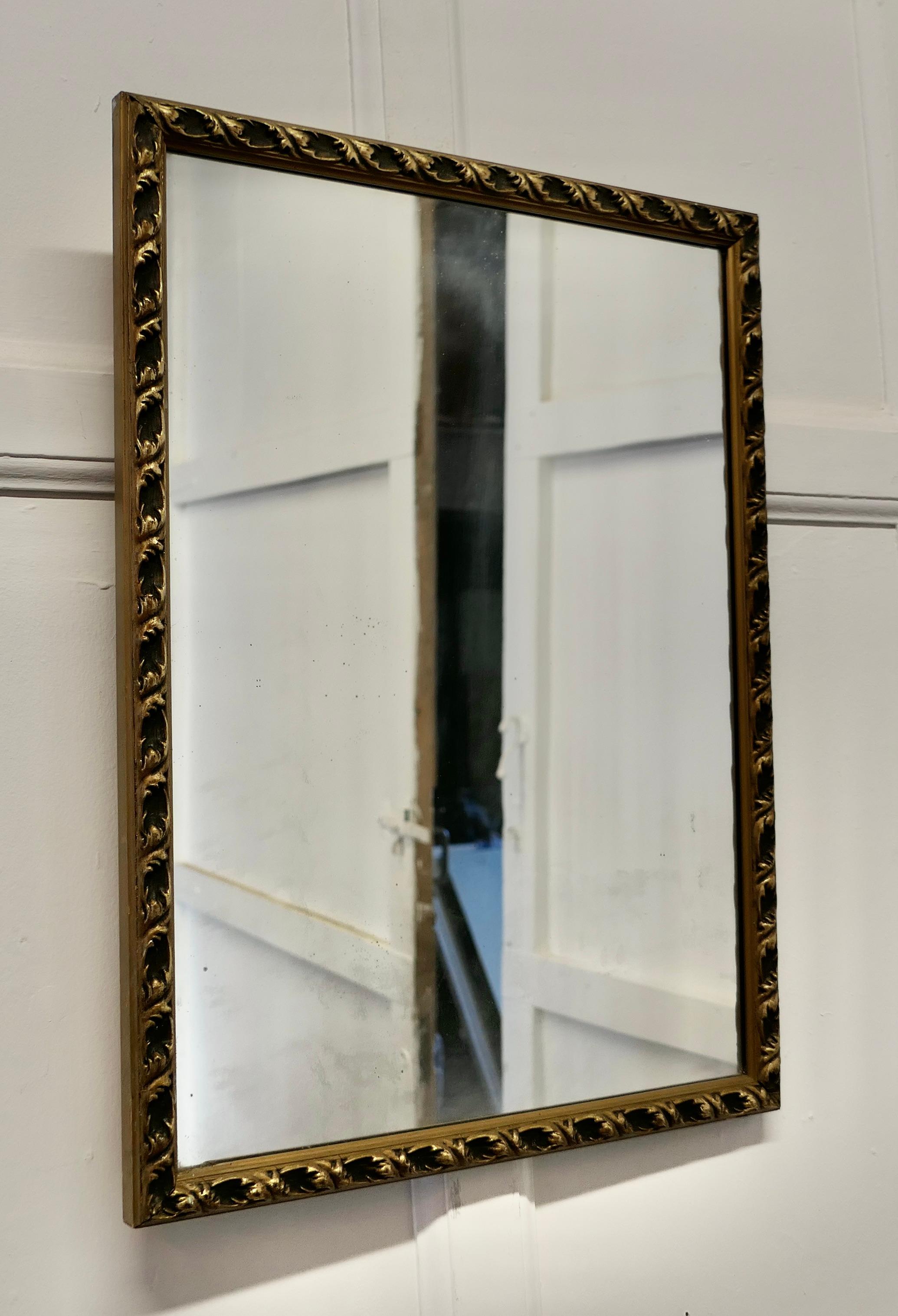 Gilt wall mirror

The Old Gold frame is 1” wide with age darkened gilt frame the looking glass is in good condition
 The mirror and carved frame are in good aged condition 
The Mirror is 24” high, 18” wide 
JK60.