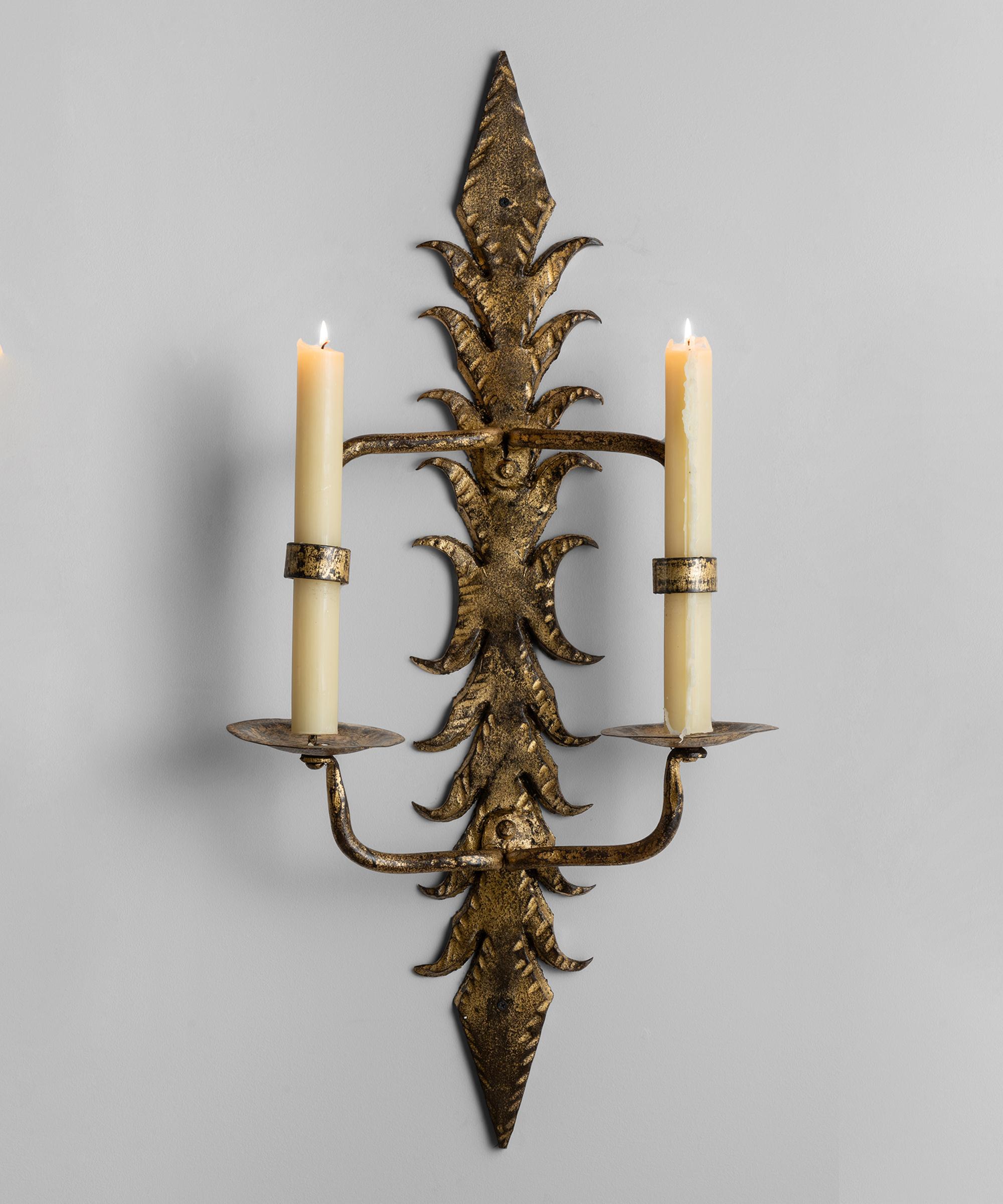 Decorative gilt metal candle lit wall sconce.


Size: 18” W x 7.75