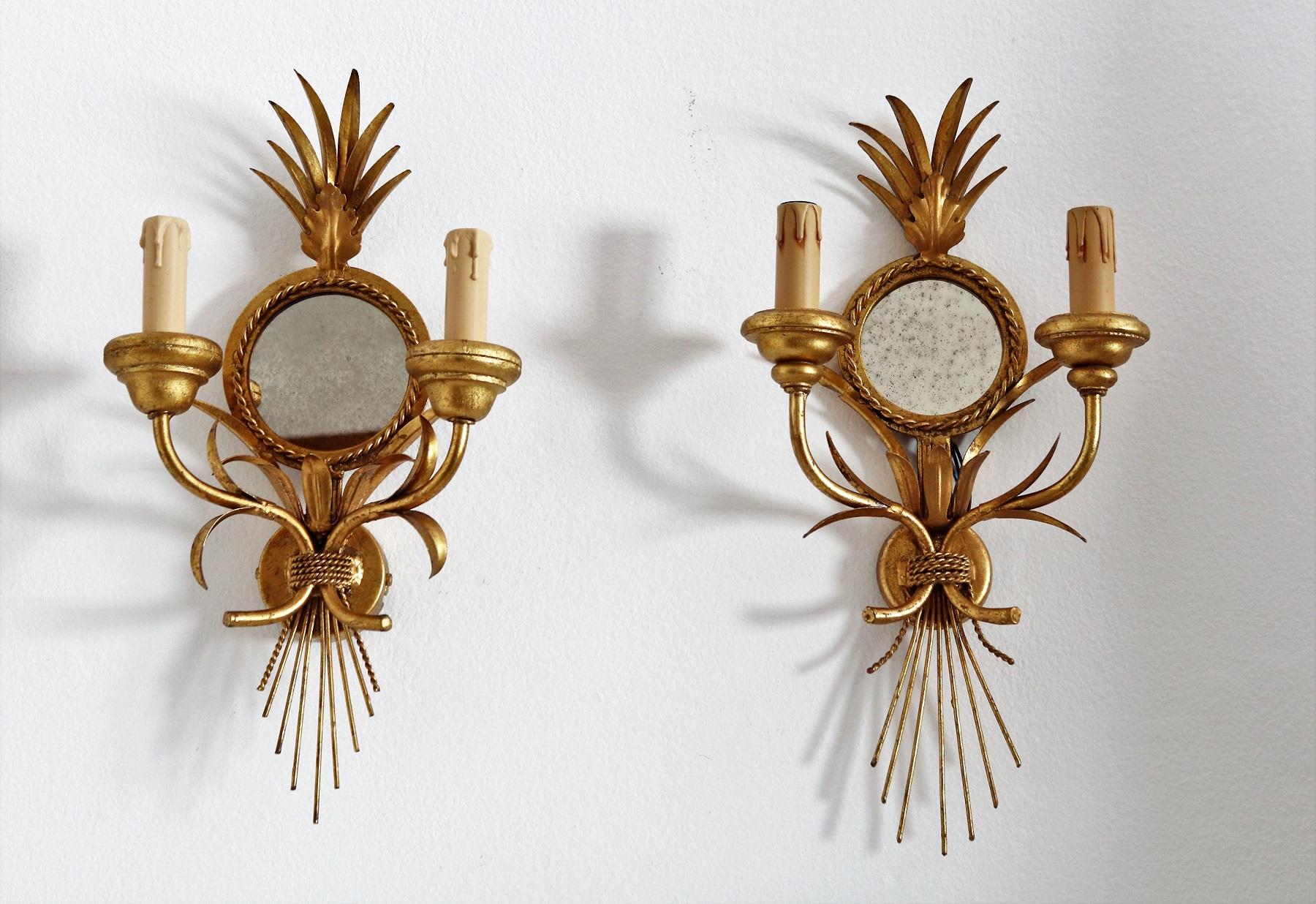Gorgeous set of three wall sconces made of gilt metal leaves and a round antique style mirror.
Made by Hans Kögl in the 1970s.
The mirror diameter of two of the wall sconces are a little smaller than the third one; and the third sconce is a little