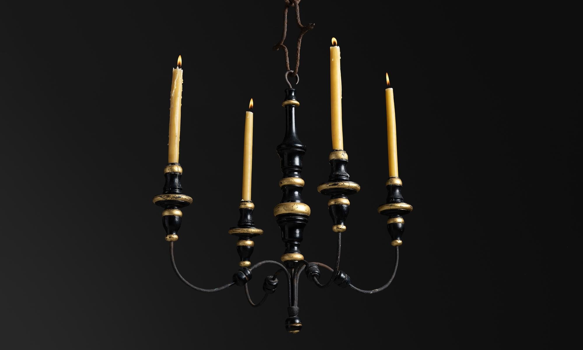 Gilt Wood Candelabra Chandelier, Spain circa 1900

Four arm candelabra with black and gilt turned wooden details and curved iron arms.