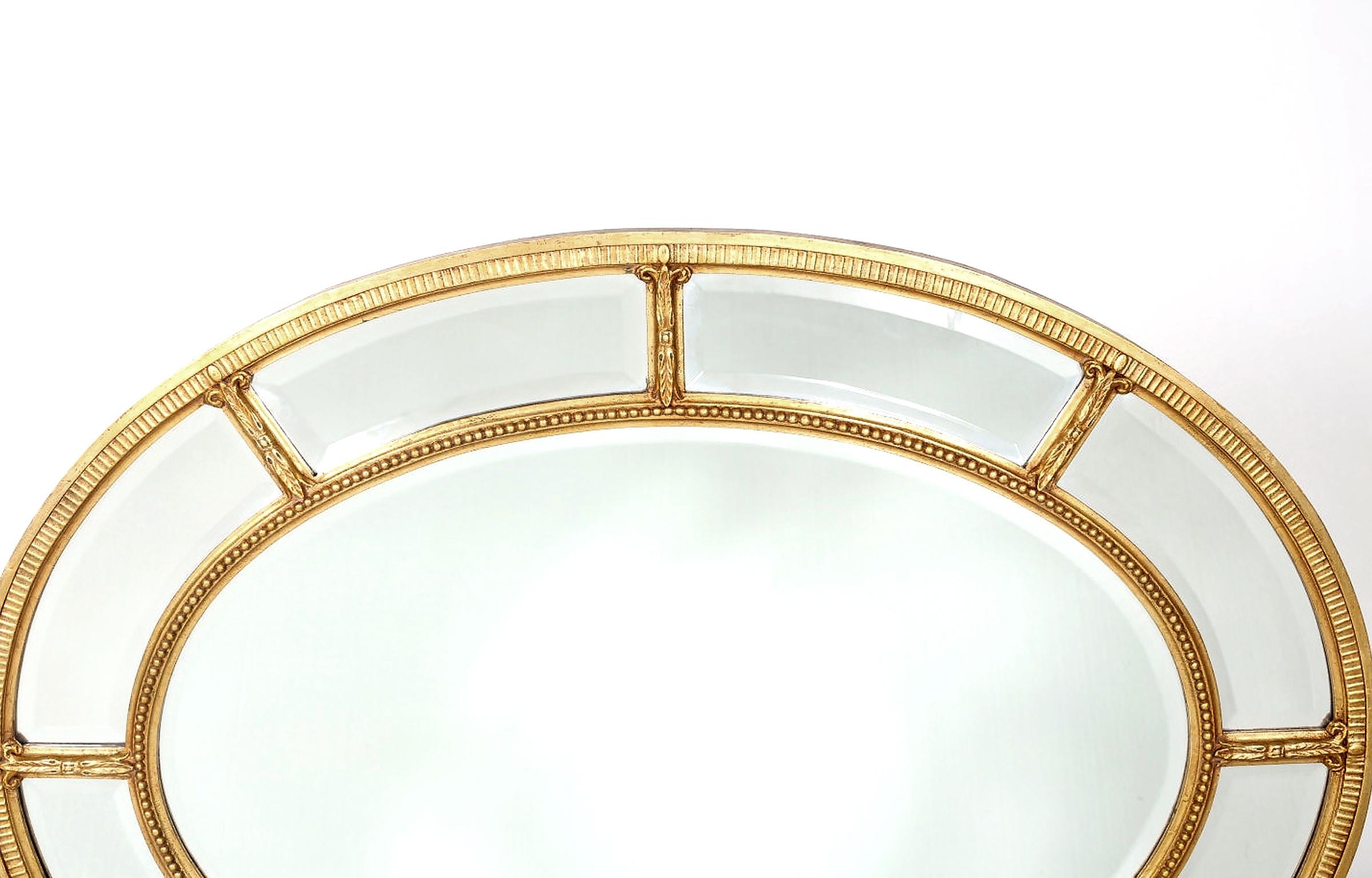 Gilt wood framed oval shape beveled hanging wall mirror . The mirror can be hanged horizontally / Vertically . Minor wear consistent with age / use . The mirror measure about 48 inches Long X 26 inches Wide