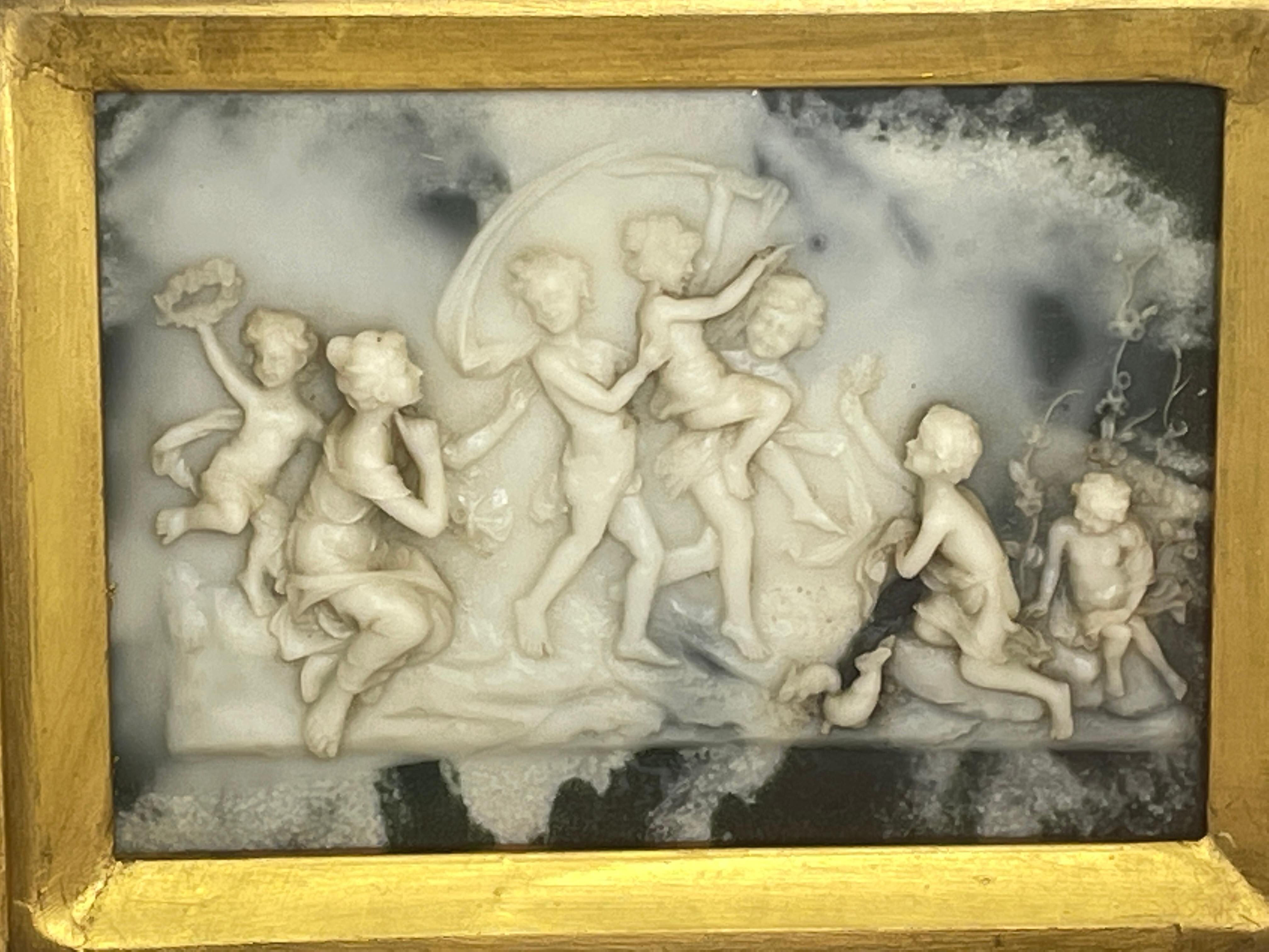 A beautiful, vintage alabaster handmade plate, framed with glass and gilt wood. Measuring 11.75