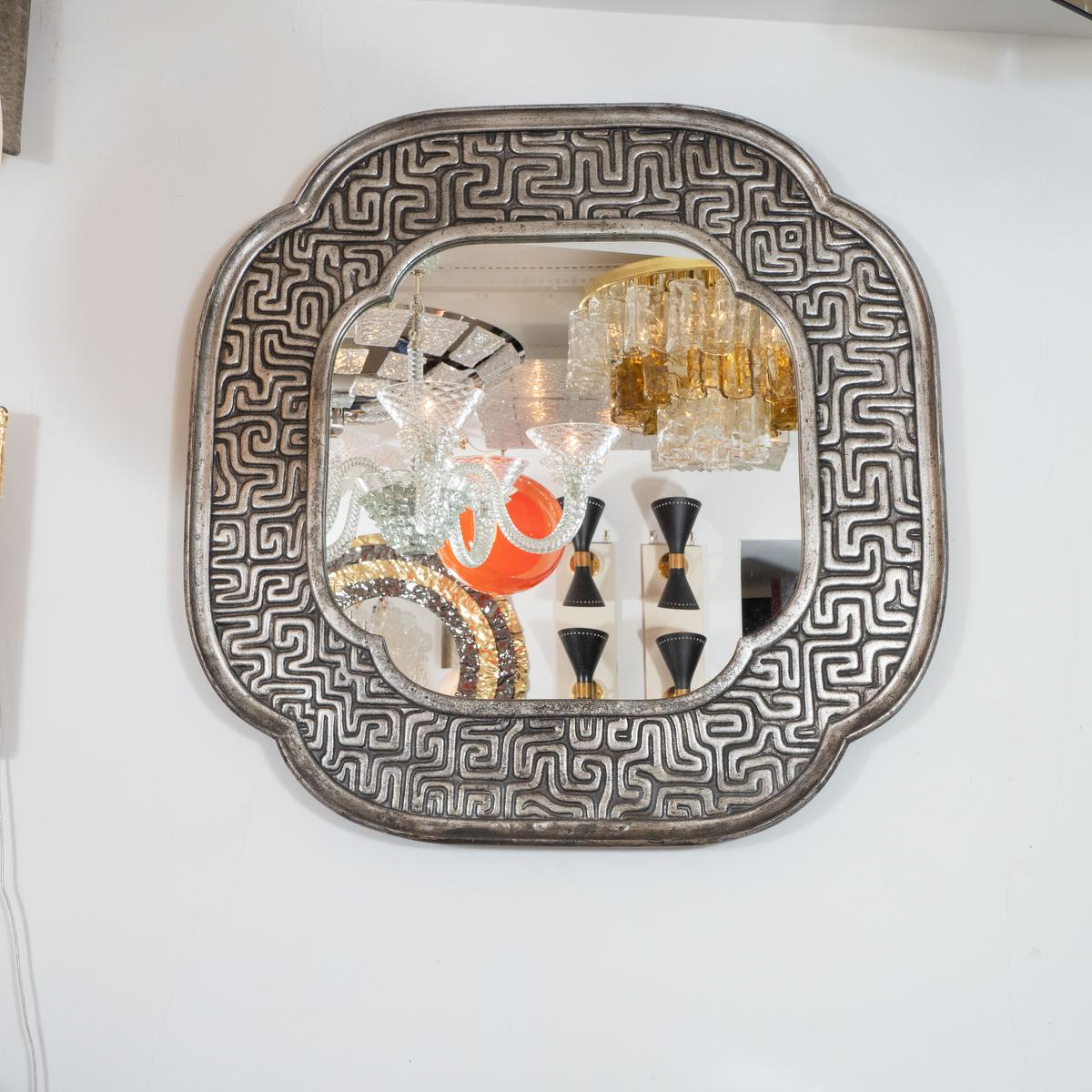 Silver giltwood mirror with Southeast Asian geometric motif surround.