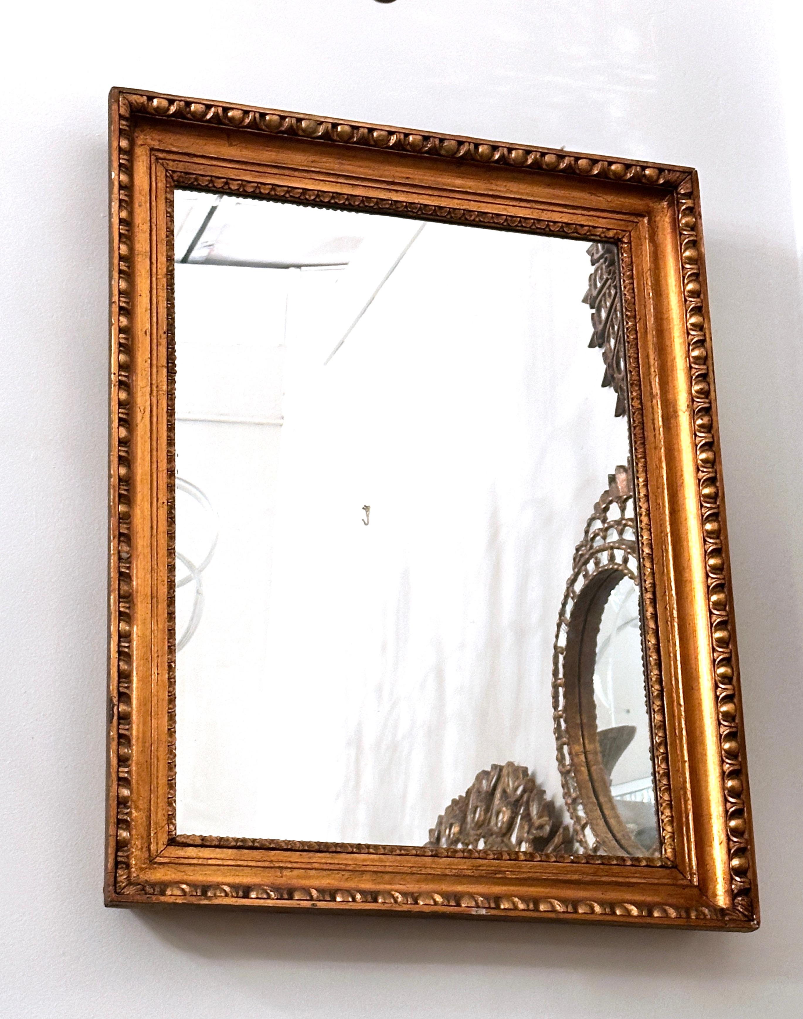 A circa 1930's neoclassic style French gilt wood mirror.

Measurements:
Height: 33.5