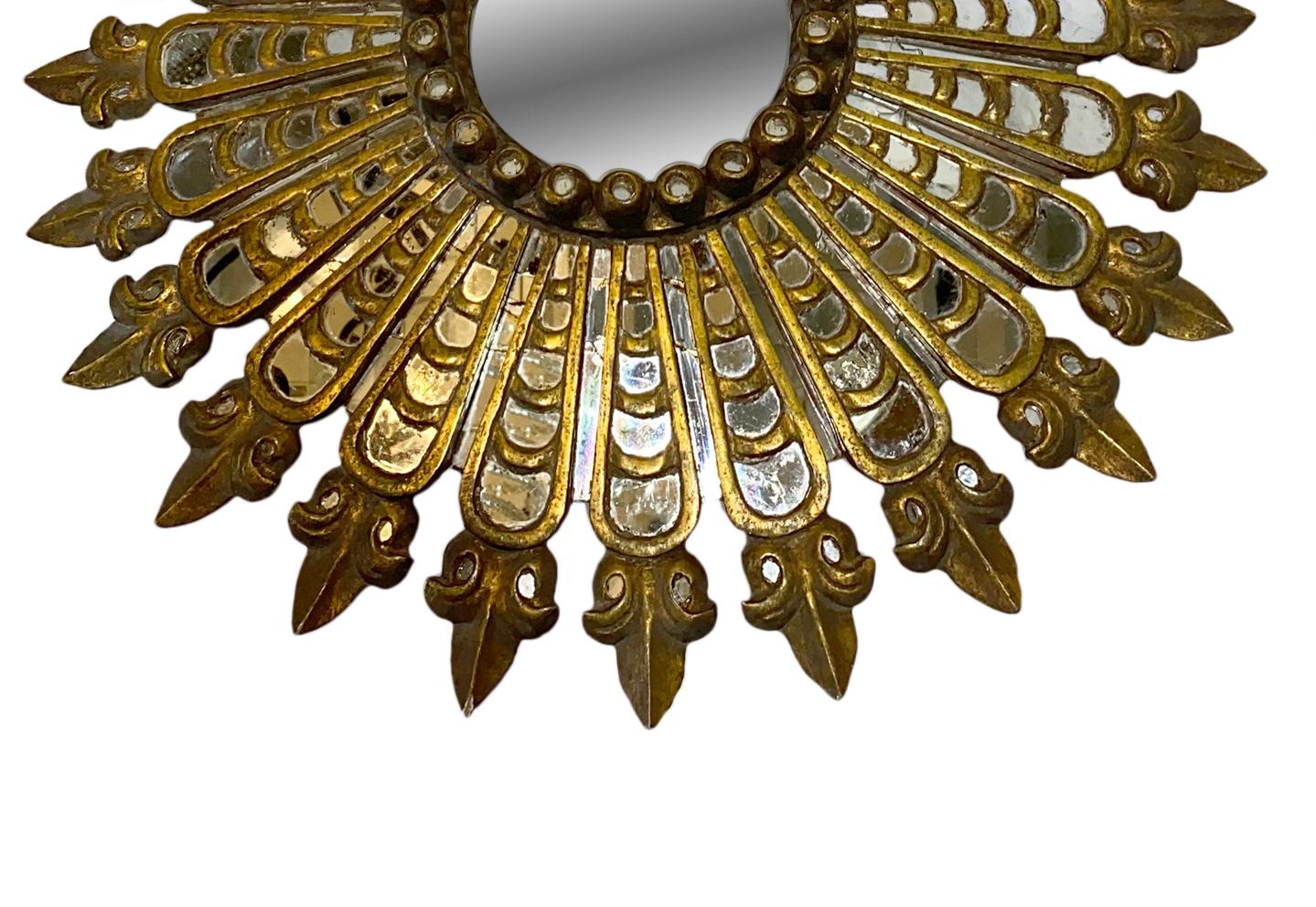 A circa 1920s Spanish giltwood sunburst mirror.

Measurements:
Diameter 23