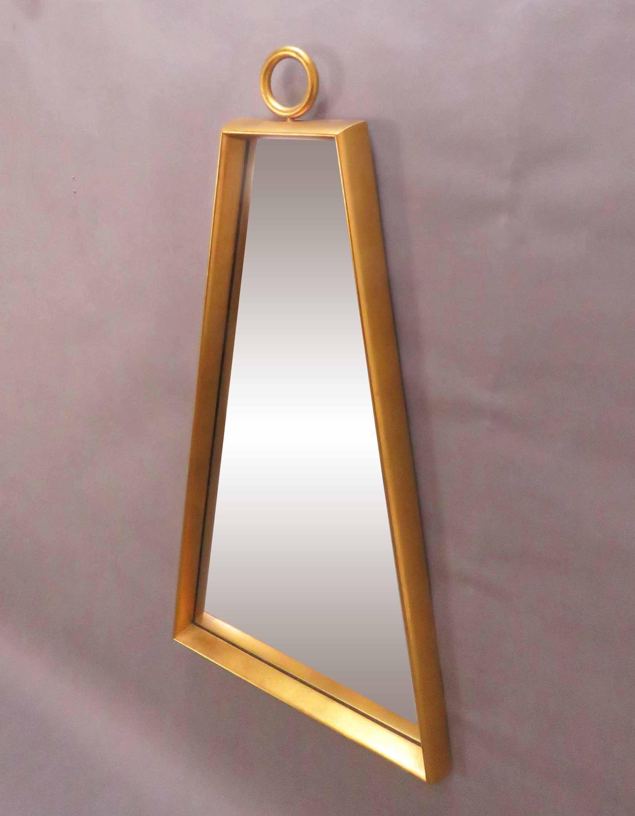 Gold leaf trapezoidal wall mirror with ring finial accent, in manner of Tommi Parzinger, circa 1960s.