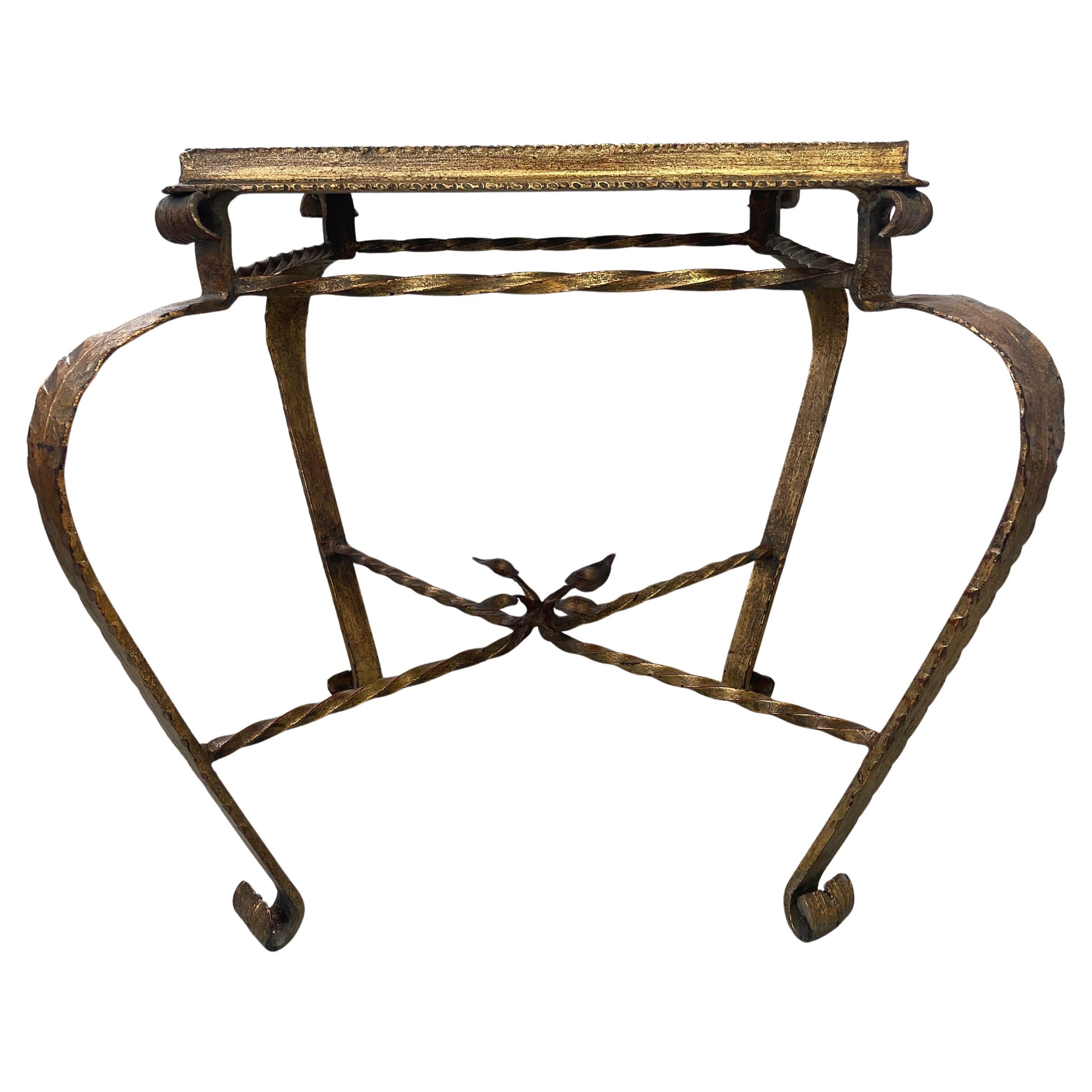 Gilt low table or side table with legs twisted and scroll details, Hand forged iron. 
Likely Spain, 1950s.
Beautiful muted red marble (likely Rosso Francia Incarnat) tabletop set into the iron frame.

Impressive and very decorative piece, made by