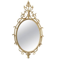 Giltwood and Carton-Pierre Robert Adam Period 'Dressed' Oval Looking-Glass