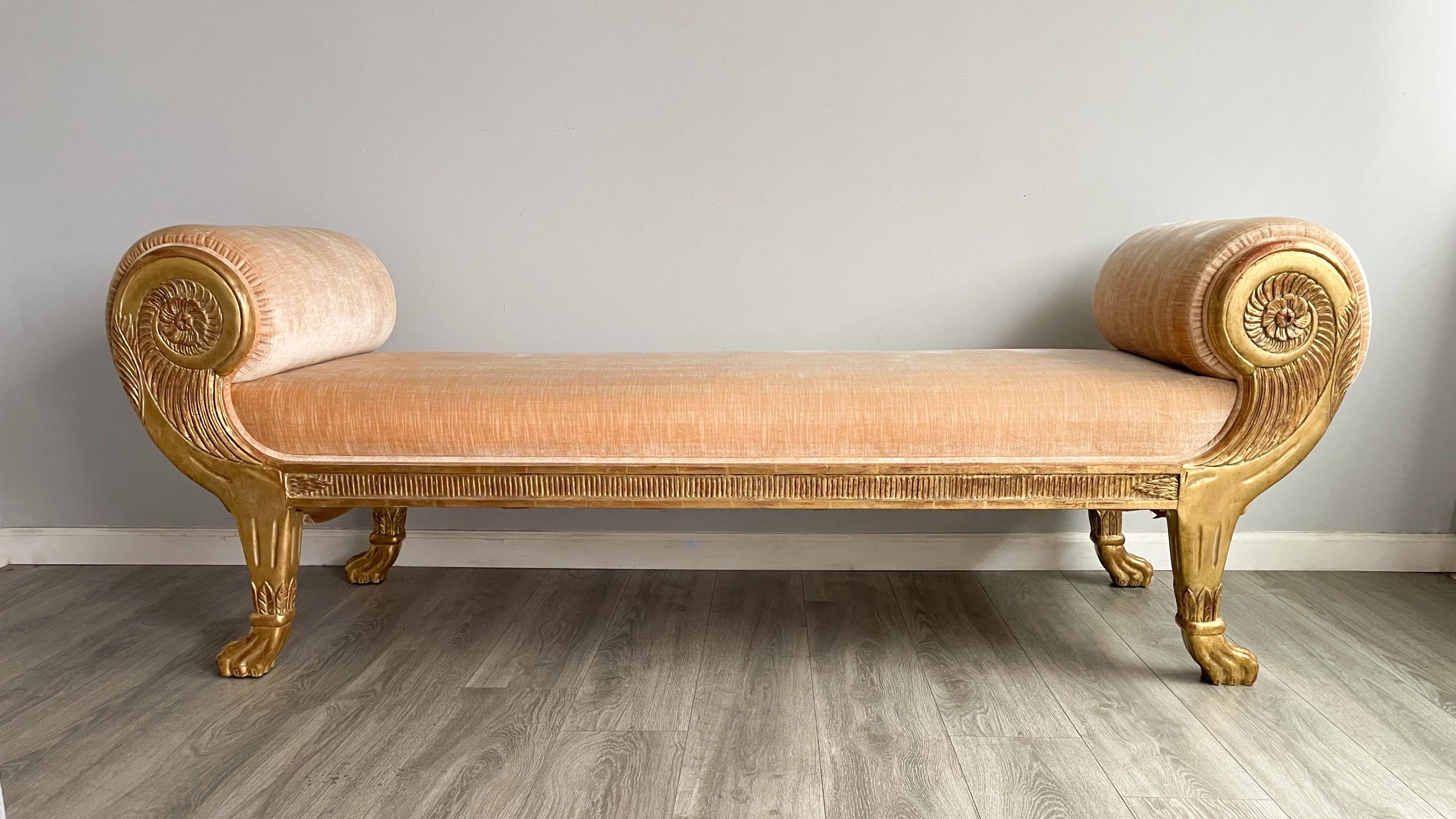 Stunning, carved gilt-wood bench with rolled arms and velvet upholstery from Ebanista/Pakzad International 

Real 24kt gold leaf finish and salmon pink velvet upholstery. 

A statement piece, perfect for traditional European or contemporary settings.
