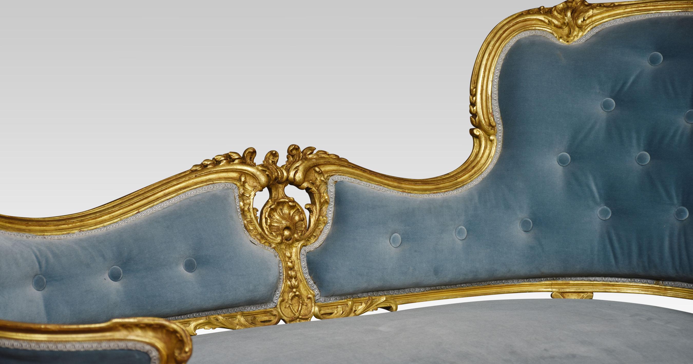 Giltwood chaise lounge, the carved moulded back rail with pierced scrolling decoration, to the deep buttoned back upholstered in light blue velvet upholstery. All raised up on cabriole legs terminating in scrolling toes.
Dimensions
Height 32
