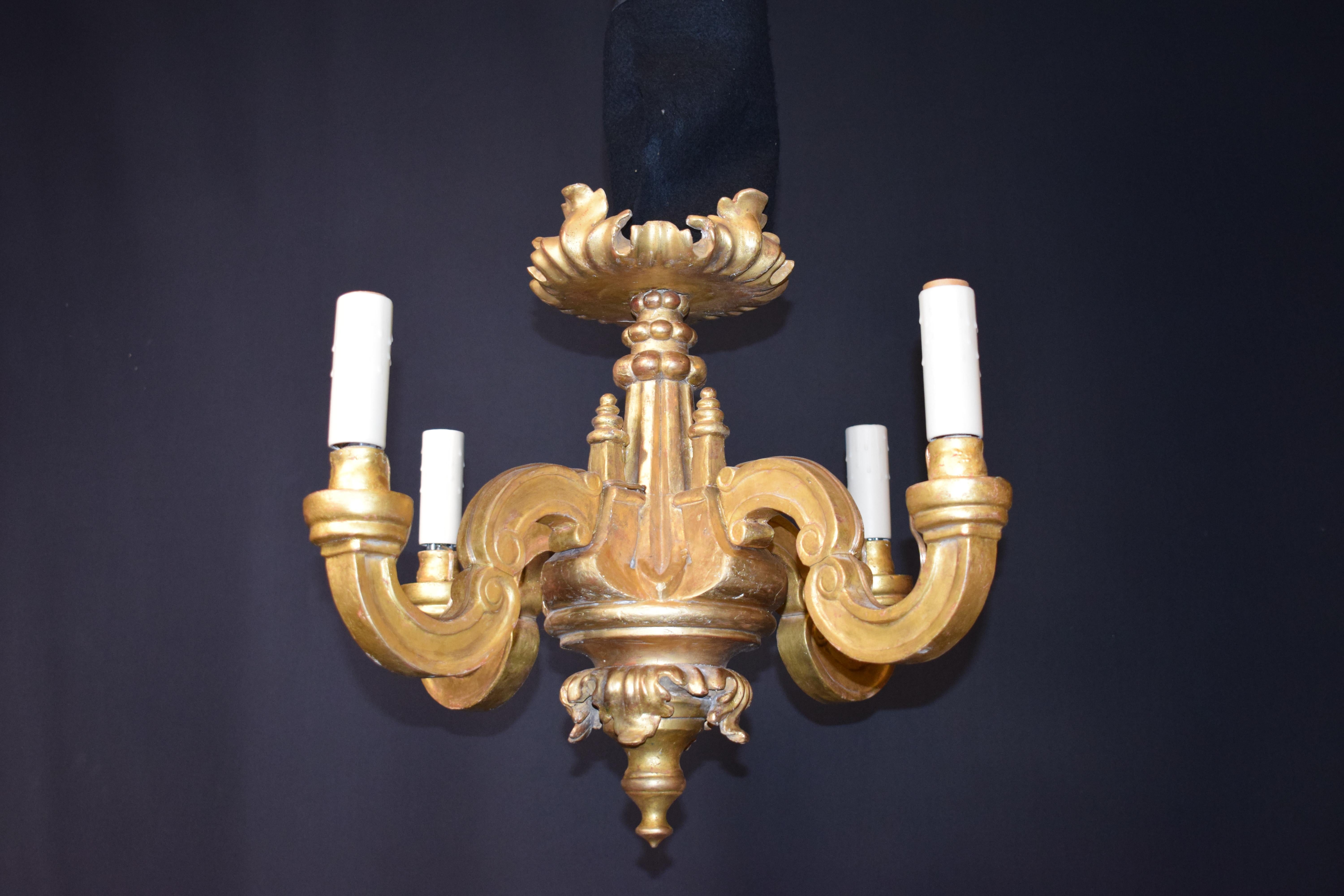 A very fine Louis XVI style carved and gilt wooden chandelier, original 24-karat gilding. Made for candles now electrified. 4-lights.
Dimensions: Height 19 1/2