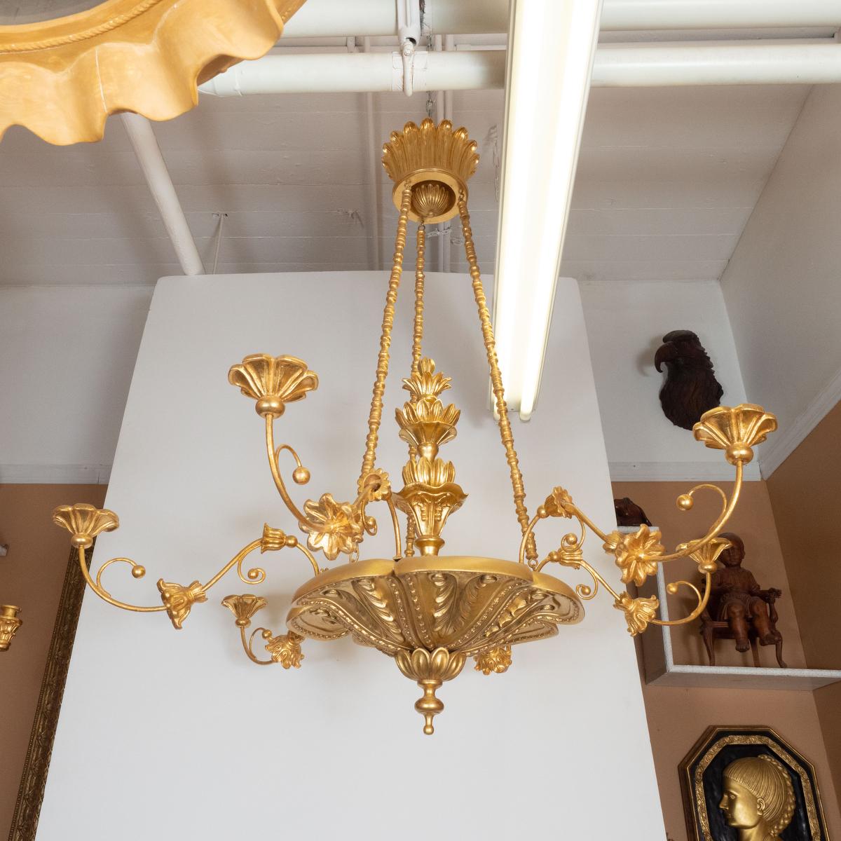 22k gold giltwood woodcarving chandelier with thin tendril arms and foliate motif by master woodworker Carlos Villegas