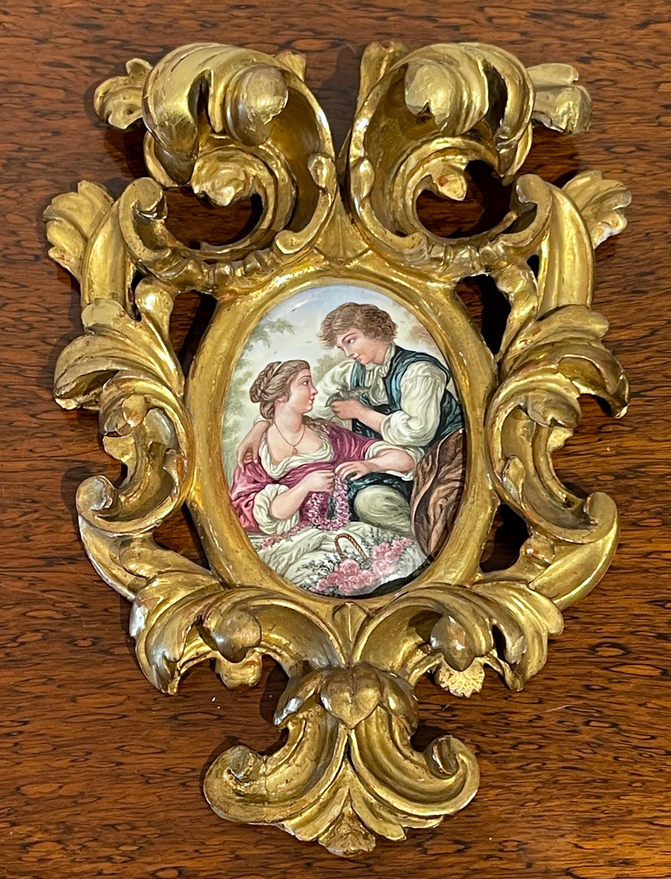 Giltwood Framed Limoges Enamel after François Boucher 'The Bird Catchers' 
France, Circa 1880s
Framed in an elaborate hand carved  pierced and giltwood  three- dimensional  Baroque style frame, The 3-Inch x 5-inch enamel on copper of  vignette of