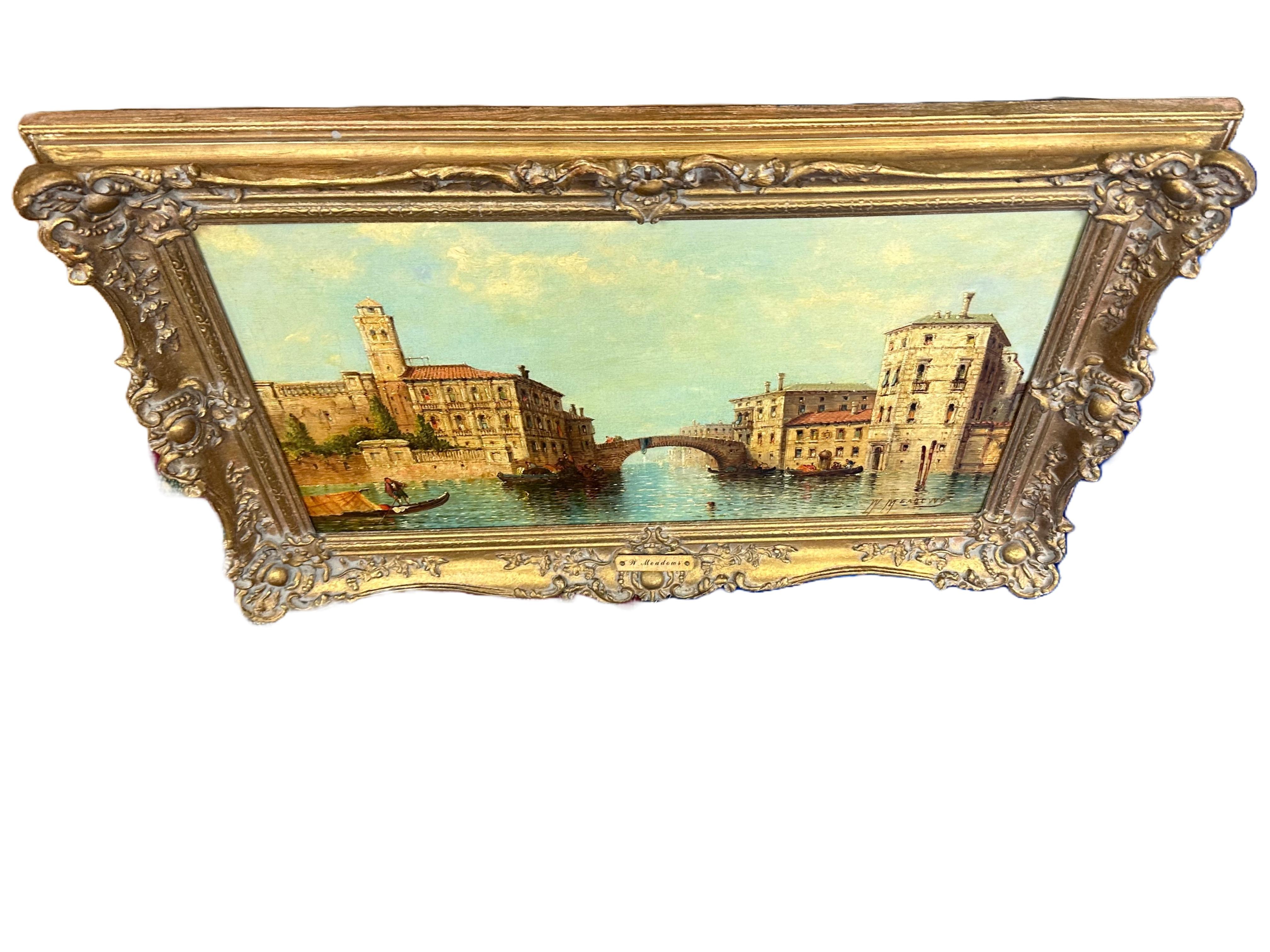 A stunning oil painting by British artist William G. Meadows of the Venice canals framed in carved giltwood. An elegantly aged patina on the back of the painting shows linen lounging over center. Meadows was born in England and lived from 1825-1907.
