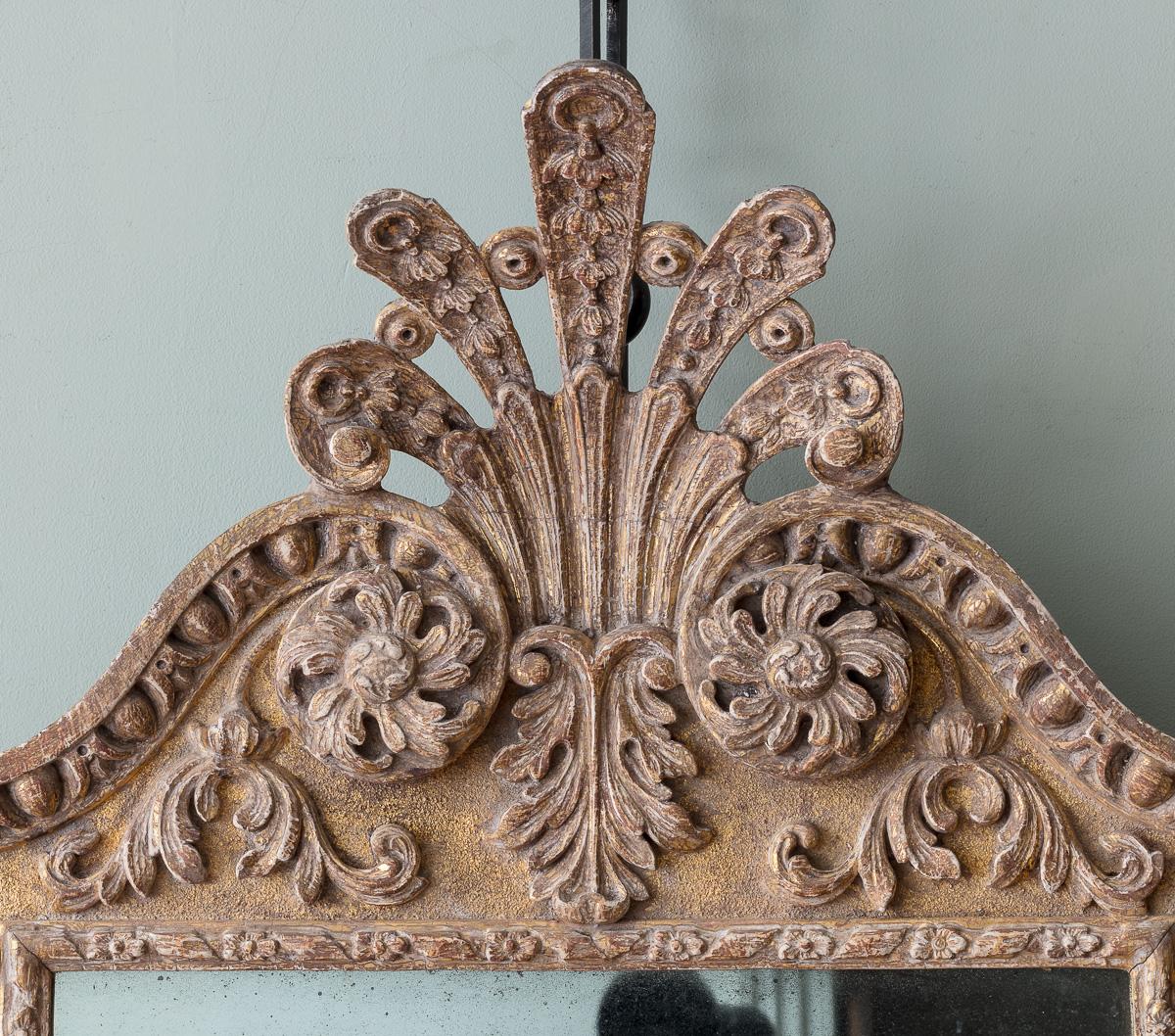 An 18th Century Giltwood Mirror, attributed to Benjamin Goodison

The quintessential Goodison designed egg and dart frame, with re entrant corners adorned with modestly carved flower motifs, with generously drawn scallop and foliate carved cresting,