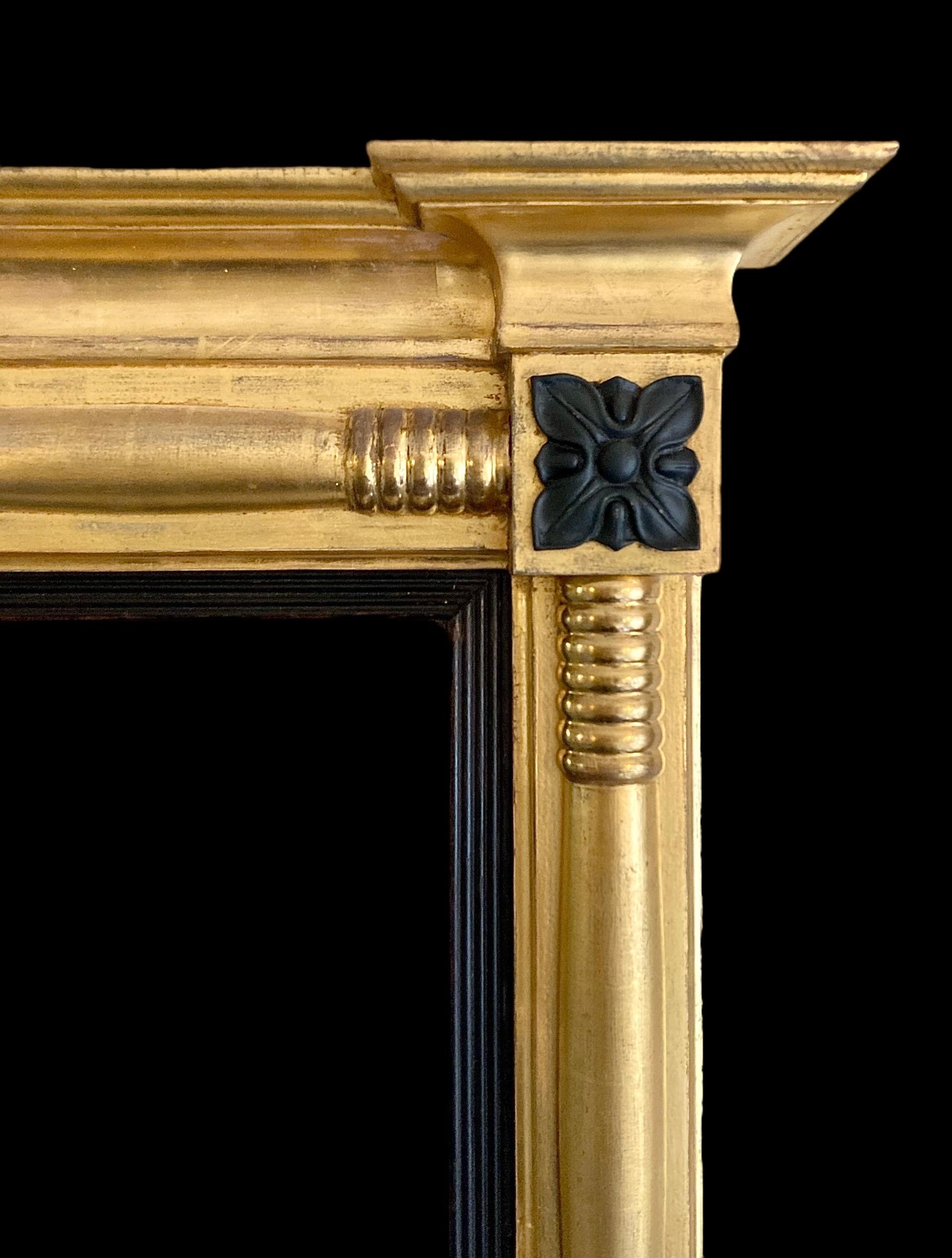 A good sized, well proportioned giltwood overmantle pier mirror with original ebonised reeded slip housing a beautifully distressed mercury mirror plate.

The mirror plate is housed by  spiral bound columns to either side and top which also feature