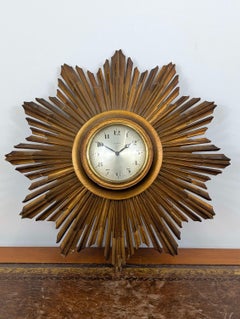 Giltwood sunburst wall clock with Swiss 8 day movement, mid 20th