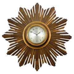 Giltwood sunburst wall clock with Swiss 8 day movement, mid 20th