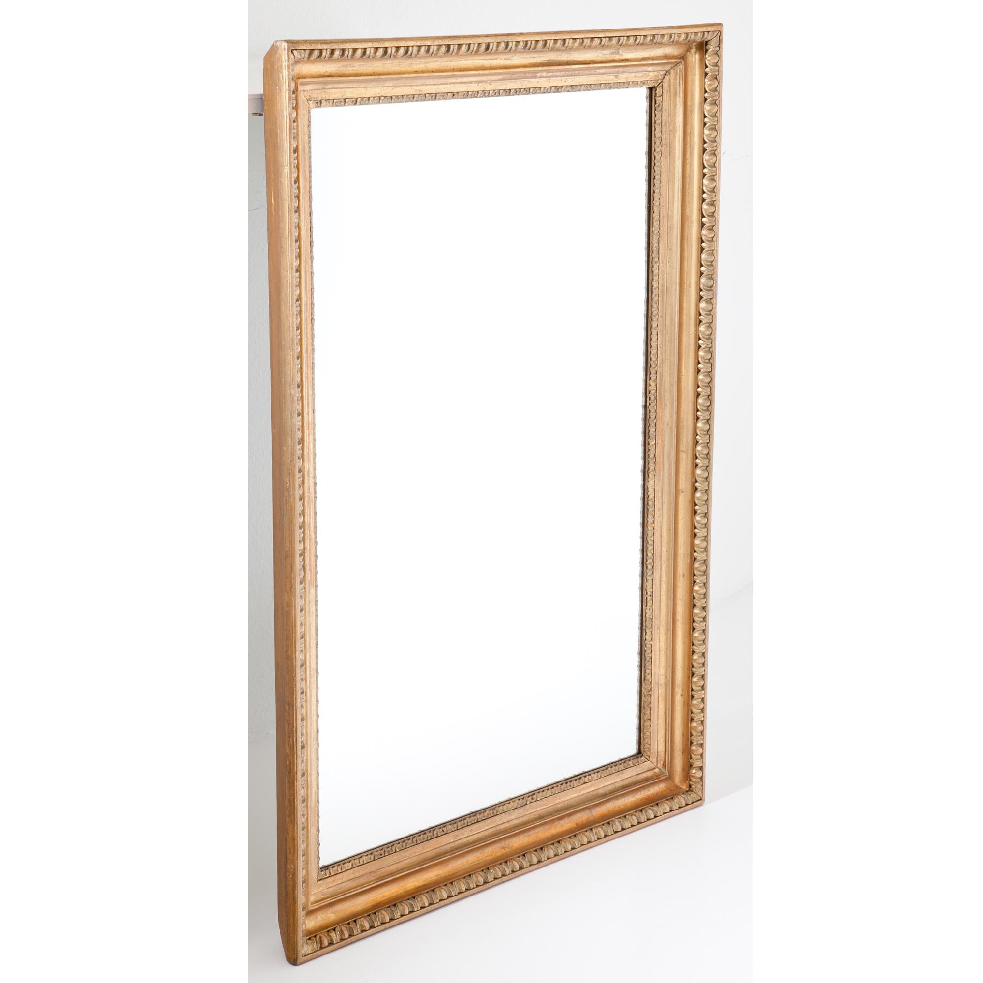 Large wall mirror with a profiled giltwood frame with cymatium molding. The mirror pane is new. Inside Dimensions: 102 x 62 cm.