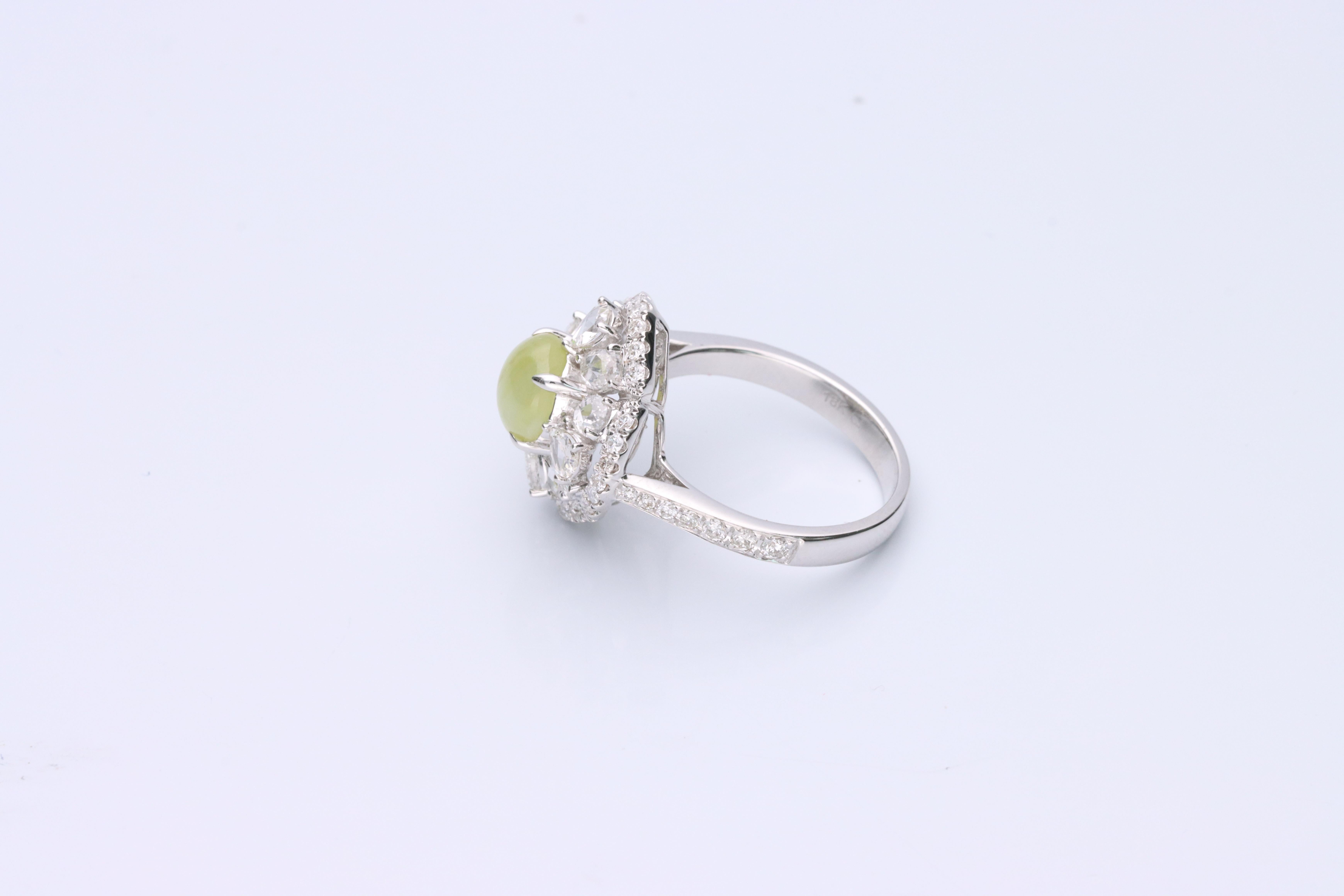 Decorate yourself in elegance with this Ring is crafted from 18-karat White Gold by Gin & Grace. This Ring is made up of Oval-Cab (1 pcs) 1.96 carat Chrysoberyl Cats Eye and Rose-cut White Diamond (12 Pcs) 1.06 Carat, Round-cut White Diamond (42