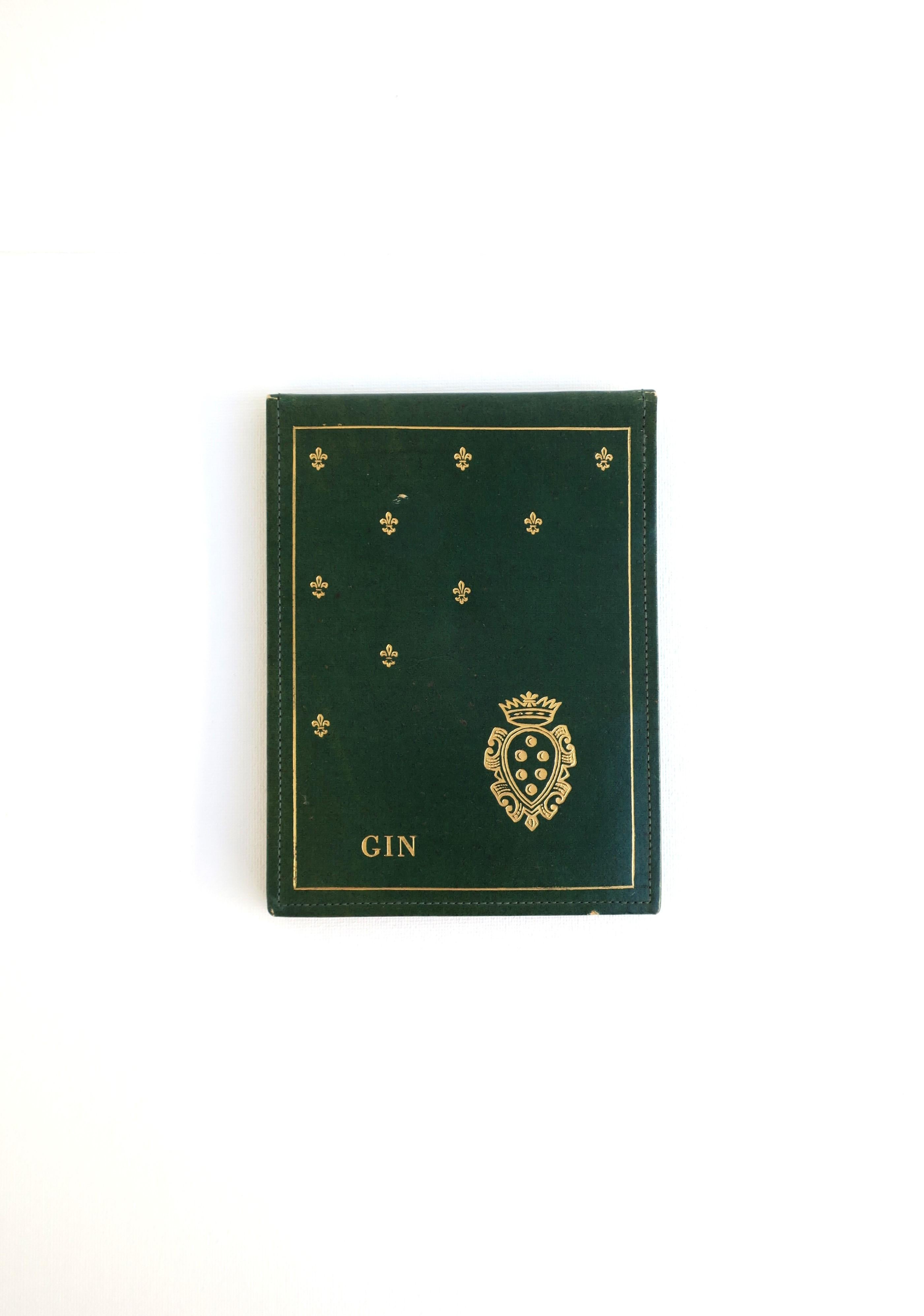 An Italian green and gold Gin card game scoring pad, circa early to mid-20th century, Italy. Piece is faux leather with gold embossing: 'Gin', crest, and Fleurs-de-lis. Marked 'Made in Italy' on lower back as shown in last image. Pad appears to have