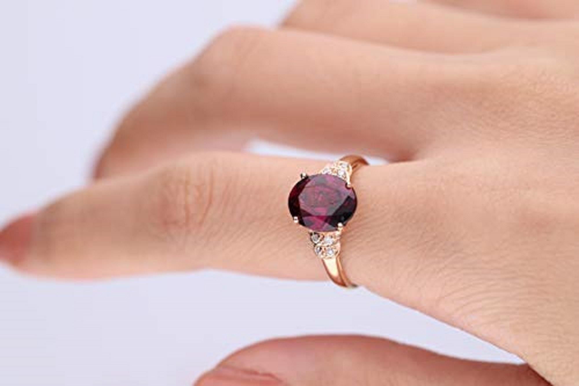 A gorgeous oval-cut Raspberry color Natural Rodholite Garnet gemstone centers this remarkable Gin & Grace ring and accented with round-cut diamonds on its sides. Crafted of beautiful 10 karat rose gold, this ring shines with a highly polished