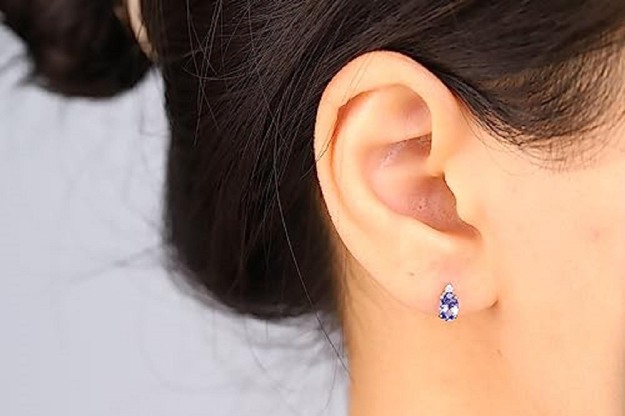 Decorate yourself in elegance with this Earring is crafted from 10-karat White Gold by Gin & Grace Earring. This Earring is made up of 6x4 mm Oval-Cut Tanzanite (2 pcs) 0.92 carat and Round-cut White Diamond (2 Pcs) 0.03 Carat. This Earring is