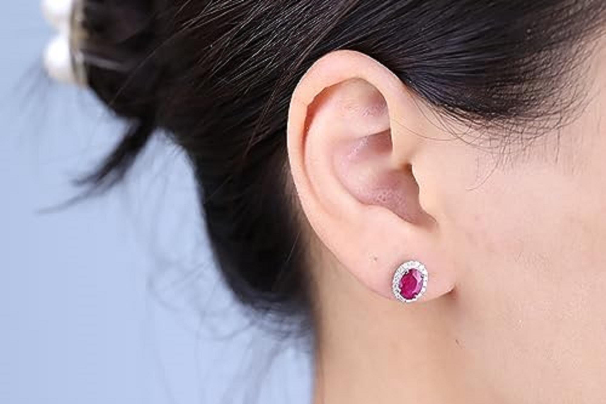 Decorate yourself in elegance with this Earring is crafted from 10-karat White Gold by Gin & Grace Earring. This Earring is made up of 7x5 mm Oval-Cut Ruby (2 pcs) 2.25 carat and Round-cut White Diamond (36 Pcs) 0.28 Carat. This Earring is weight