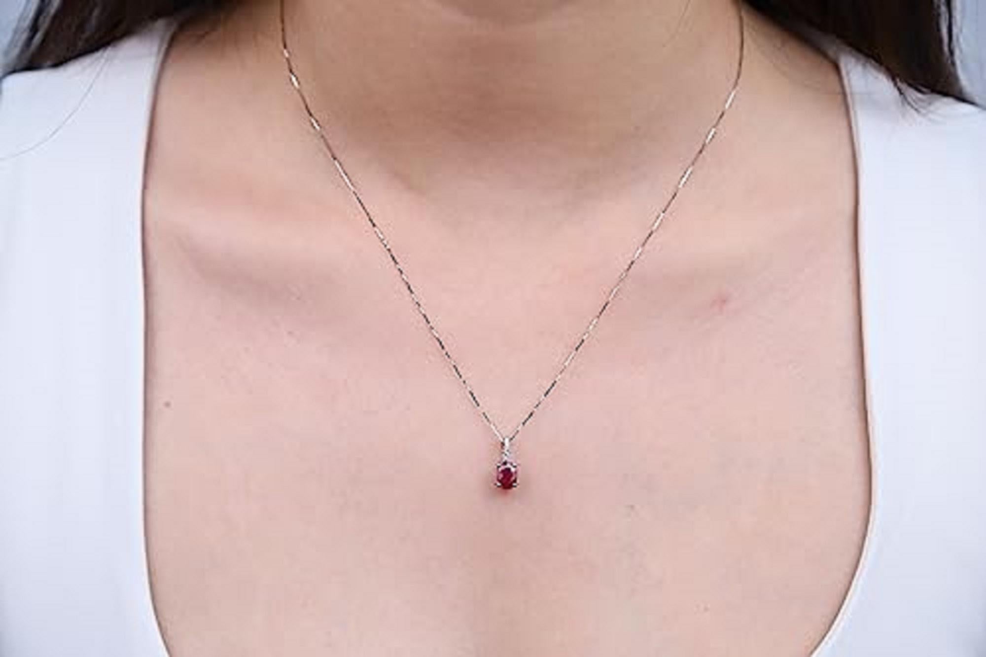 Decorate yourself in elegance with this Pendant is crafted from 10-karat White Gold by Gin & Grace. This Pendant is made up of 7x5 mm Oval Ruby (1 pcs) 1.06 carat and Round-cut White Diamond (5 Pcs) 0.04 Carat. This Pendant is weight 0.63 grams.