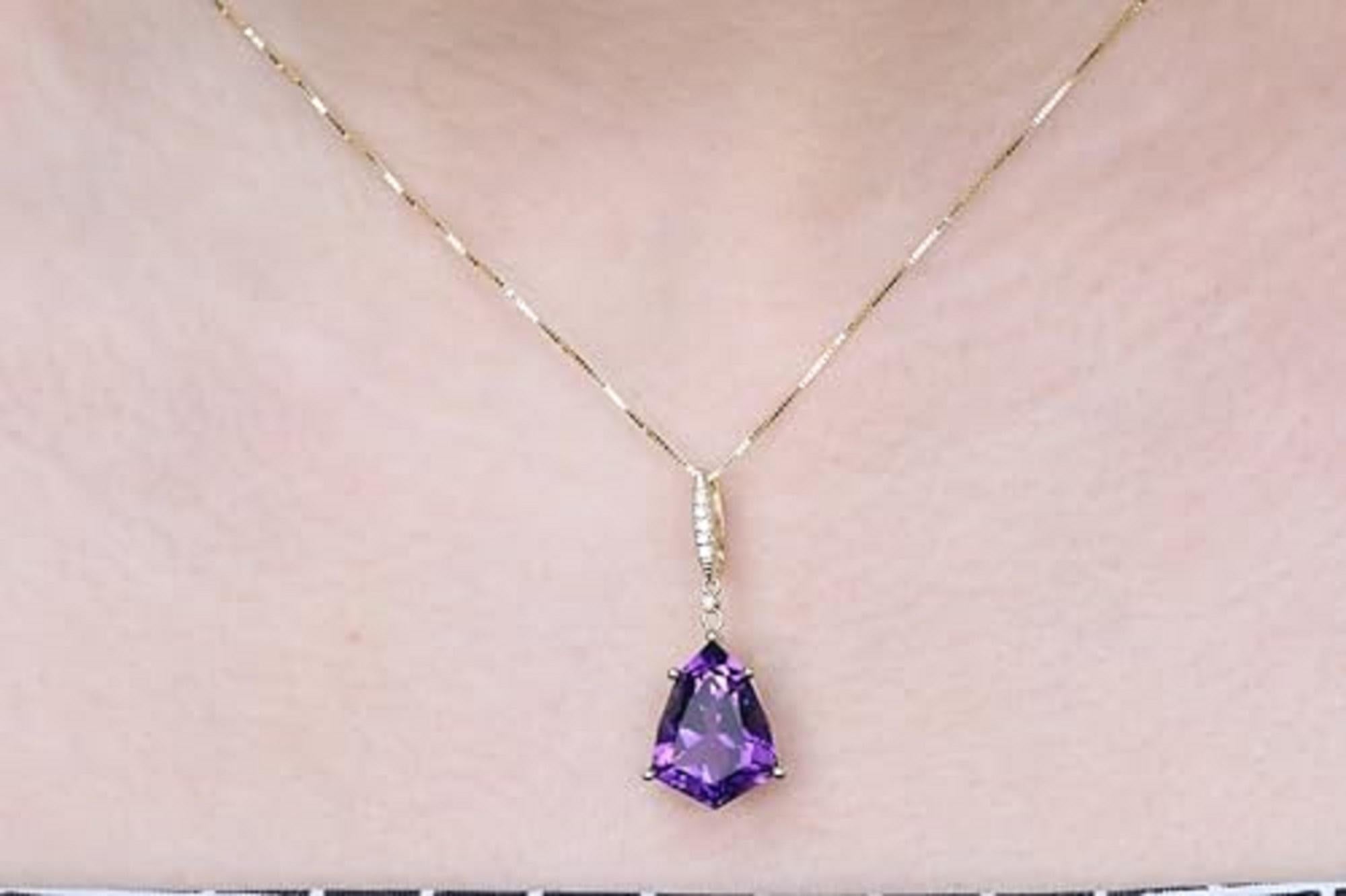 Decorate yourself in elegance with this Pendant is crafted from 10-karat Yellow Gold by Gin & Grace. This Pendant is made up of fancy Pear-cut Amethyst (1 pcs) 7.12 carat and round-cut White Diamond (6 Pcs) 0.04 Carat.This Pendant is weight 1.62