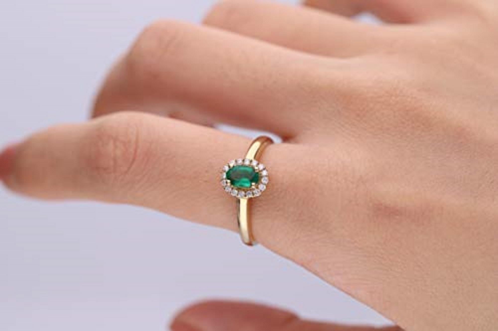 Showcasing a large prong-set oval Emerald, this Gin & Grace ring is surrounded by sixteen round-cut white diamonds. This eye-catching ring is crafted of 10k Yellow gold jewelry, creating a subtle blush. Gemstone colors: Green Gemstone shapes: Oval