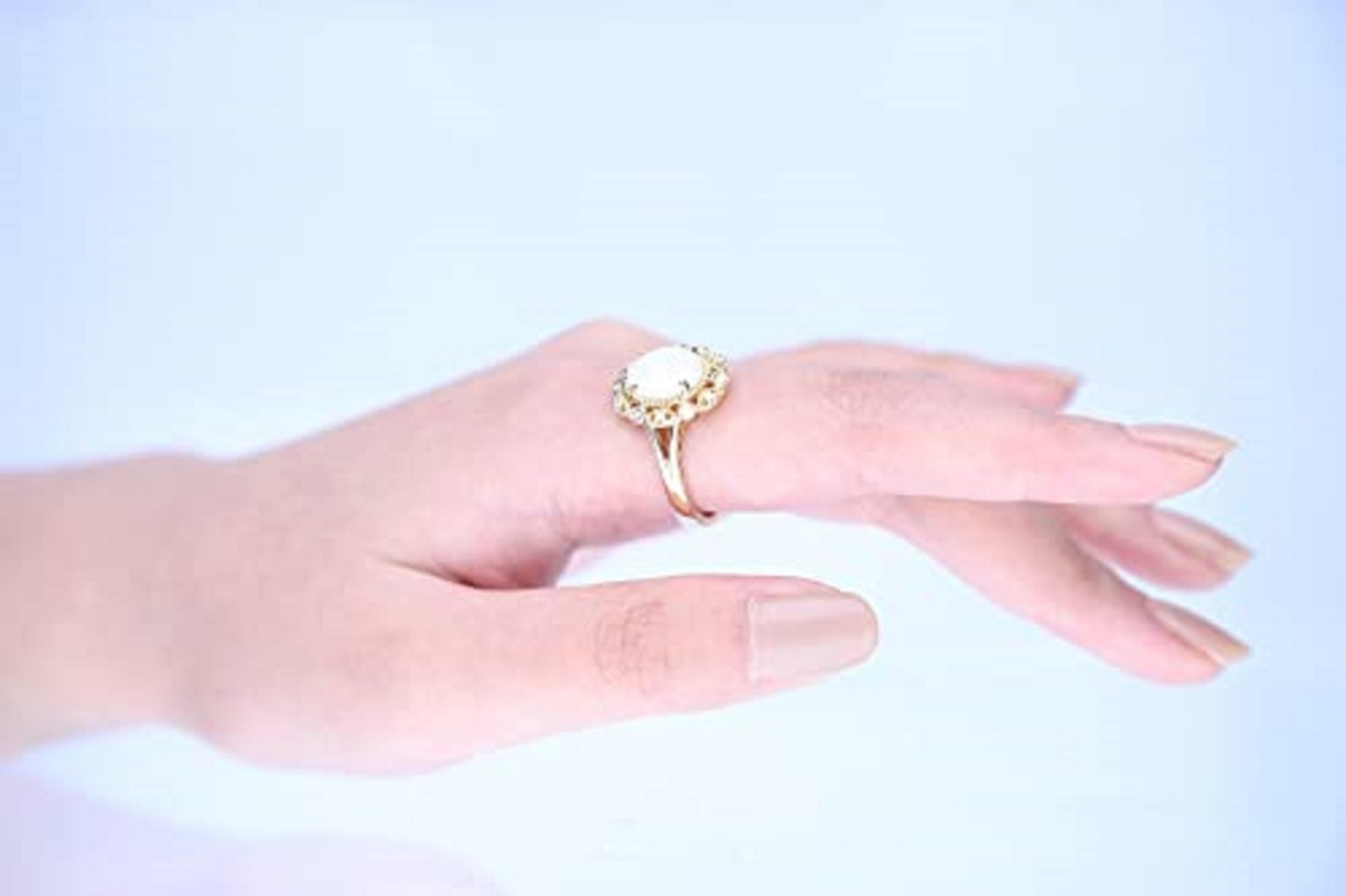 Decorate yourself in elegance with this Ring is crafted from 10-karat Yellow Gold by Gin & Grace. This Ring is made up of 8*10 mm Oval-cut (1 pcs) 1.52 carat Opal and Round Cut Diamond (12 Pcs) 0.10 Carat . This Ring is weight 4.56 grams. This