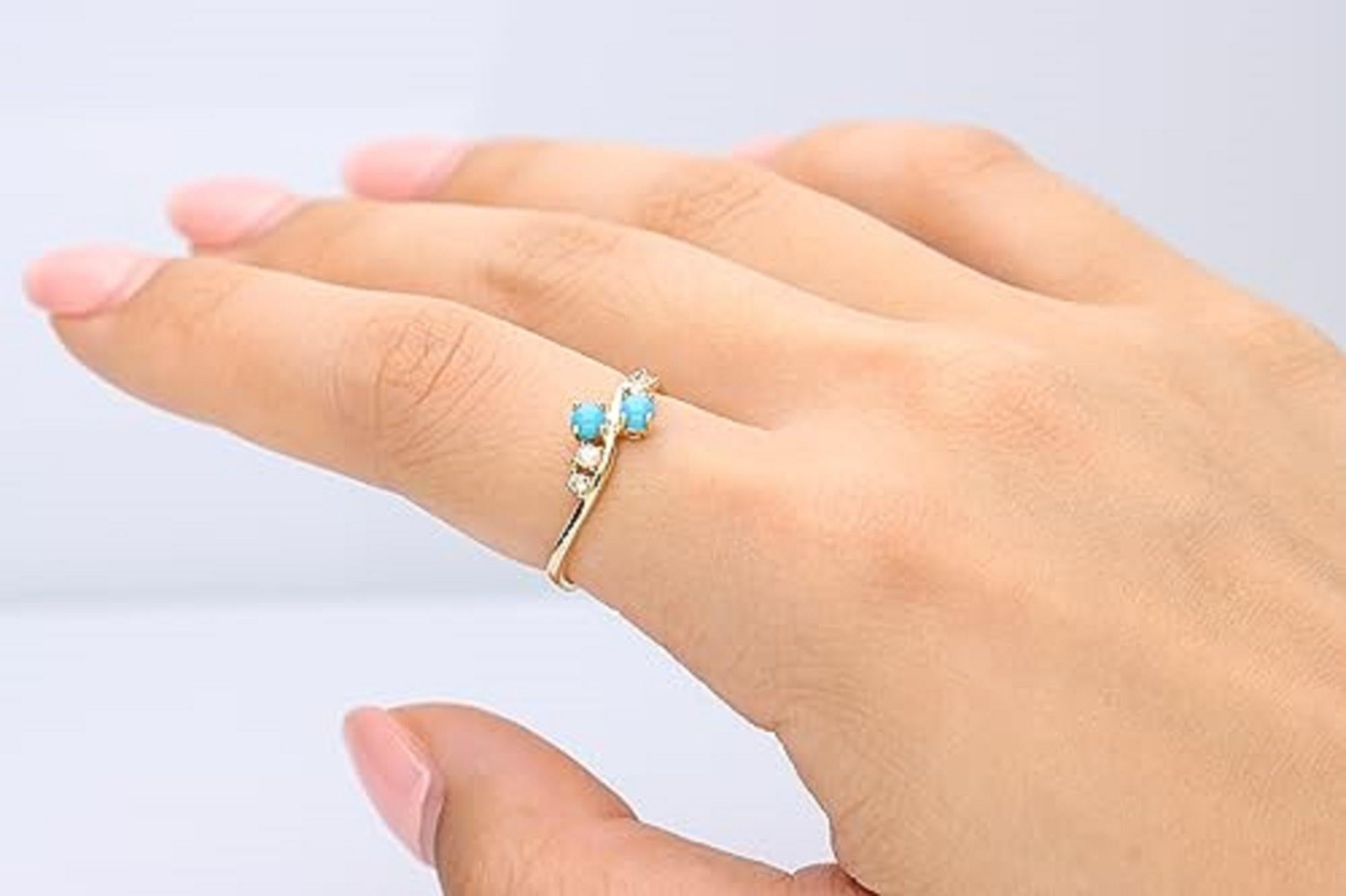 Decorate yourself in elegance with this Ring is crafted from 10-karat Yellow gold 3.0 mm Round-cut Turquoise (2 pcs) 0.29 carat and round-cut white diamond (4 pcs) 0.11 carat. This Ring is weight 1.51 grams. This delicate Ring is polished to a high