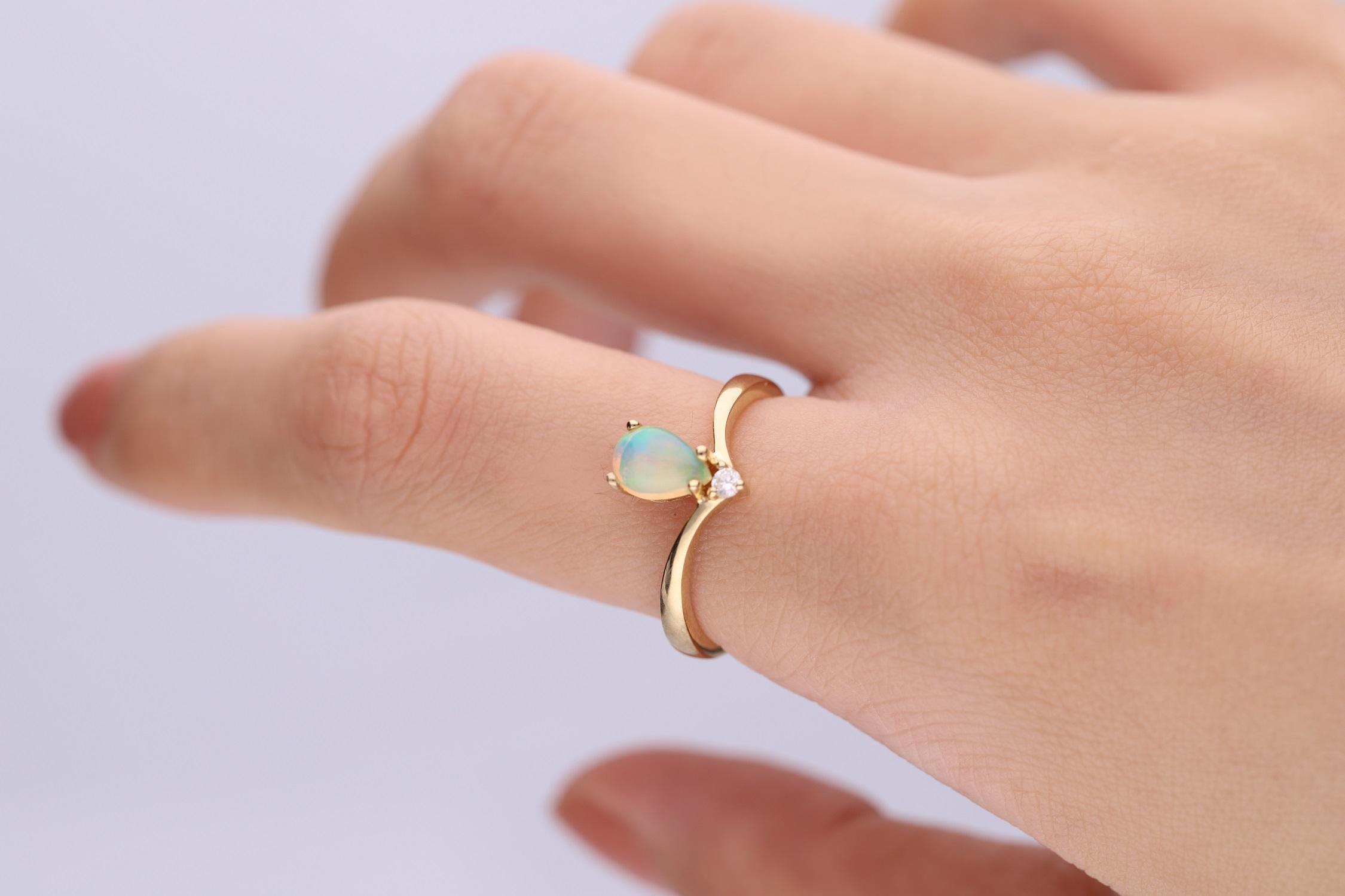 Decorate yourself in elegance with this Ring is crafted from 10-karat Yellow Gold by Gin & Grace. This Ring is made up of Pear-Cab (1 pcs) 0.51 carat Ethiopian Opal and Round-cut White Diamond (1 Pcs) 0.03 carat. This Ring is weight 2.46 grams. This