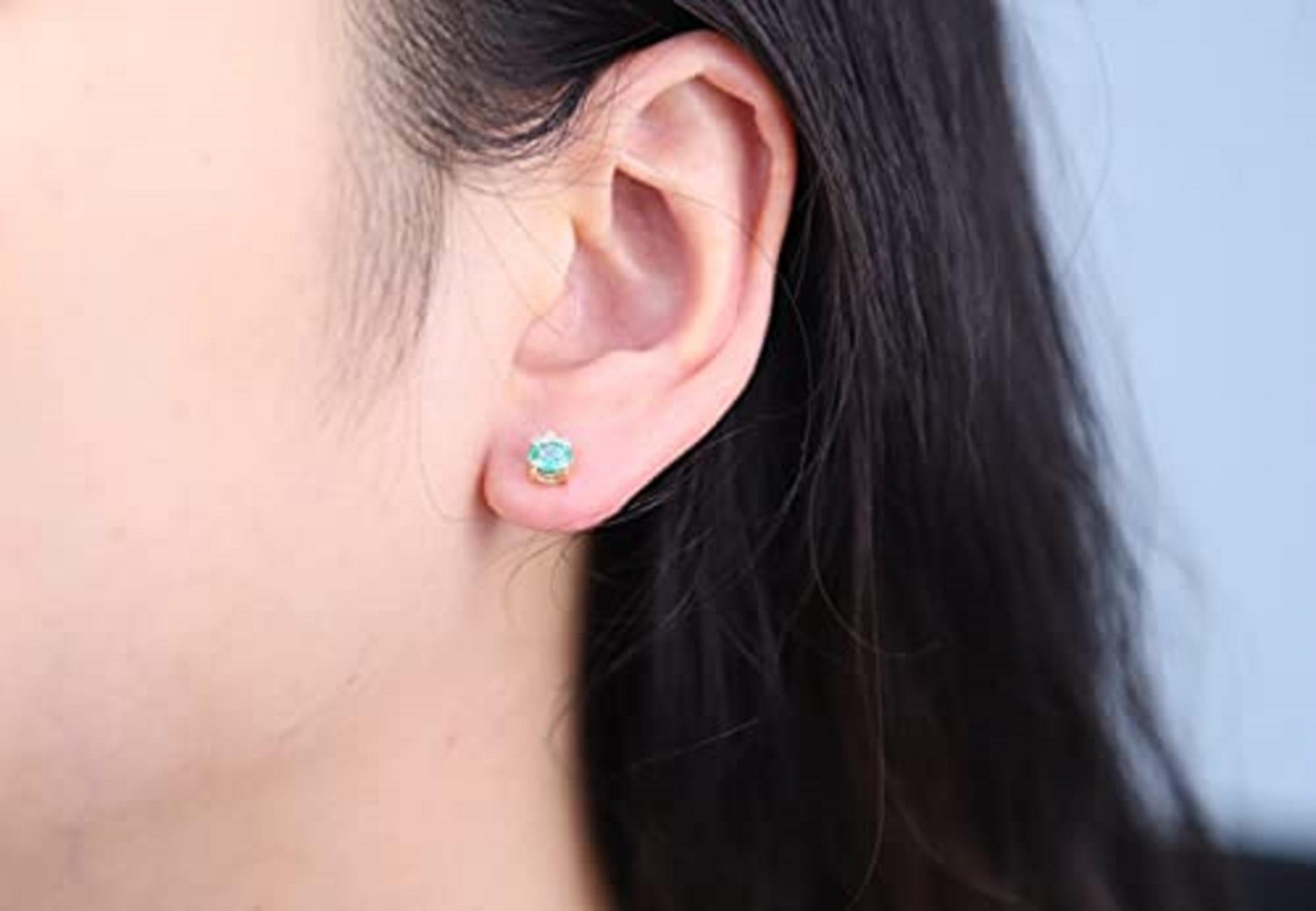 Decorate yourself in elegance with this Earring is crafted from 10-karat White Gold by Gin & Grace. This Earring is made up of 5x4 mm Oval-Cut Zambian Emerald (2 pcs) 0.56 carat and Round-cut Diamond (6 pcs) 0.06 Carat. This Earring is weight 0.94