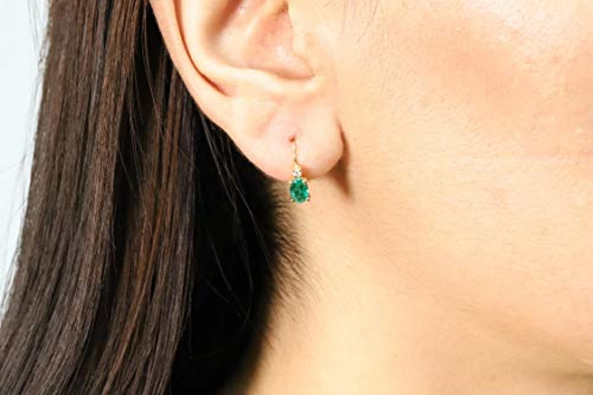 Decorate yourself in elegance with this Gin & Grace pair of earrings. The jewelry boasts oval-cut Natural emerald and Natural diamond accent stones for a gorgeous design. Style: Dangle Gemstone colors: Emerald Gemstone shapes: Oval Two prong-set