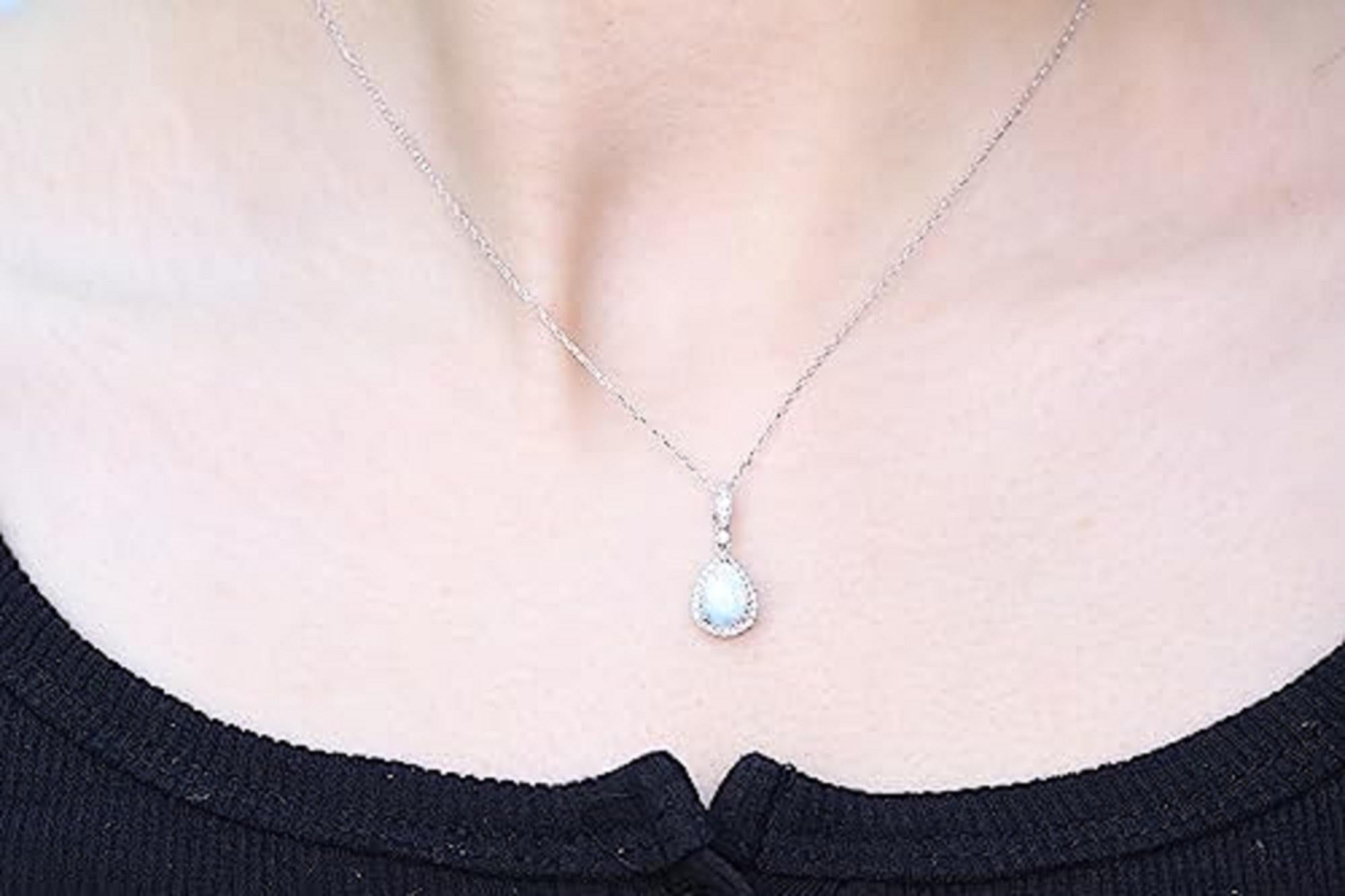 Decorate yourself in elegance with this Pendant is crafted from 14-karat White Gold by Gin & Grace Pendant. This Pendant is made up of 6*8 Pear-cut Prong setting Ethiopian opal (1 Pcs) 1.81 Carat and Round-Cut Prong setting White Diamond (28 Pcs)